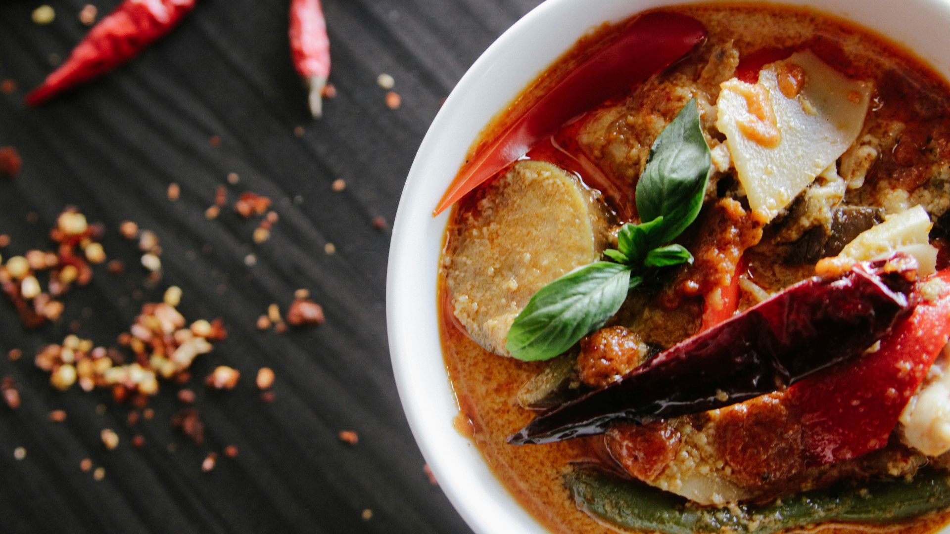 flat-lay photography of vegetable soup on white ceramic cup
