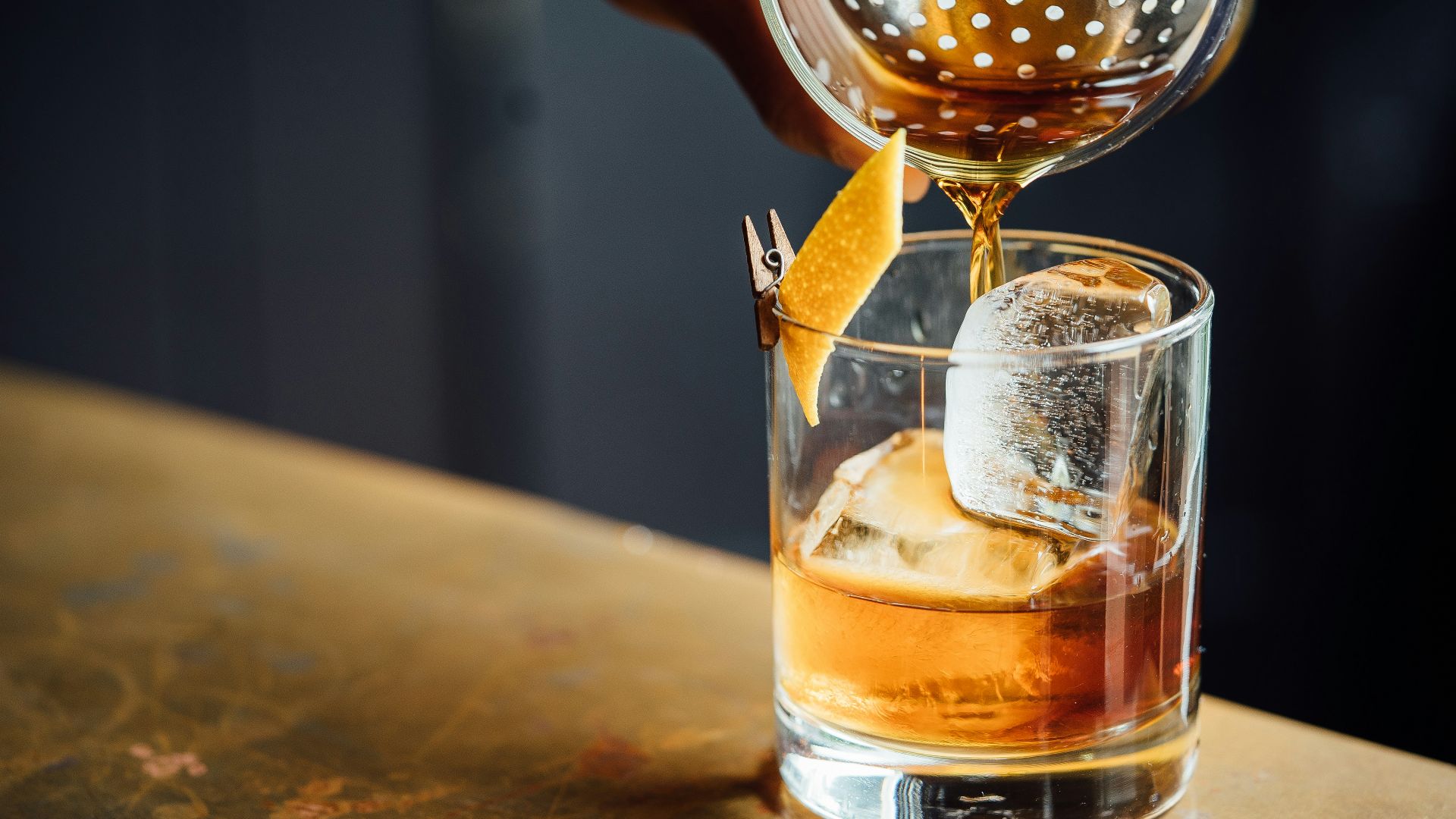 liquor pouring on clear shot glass