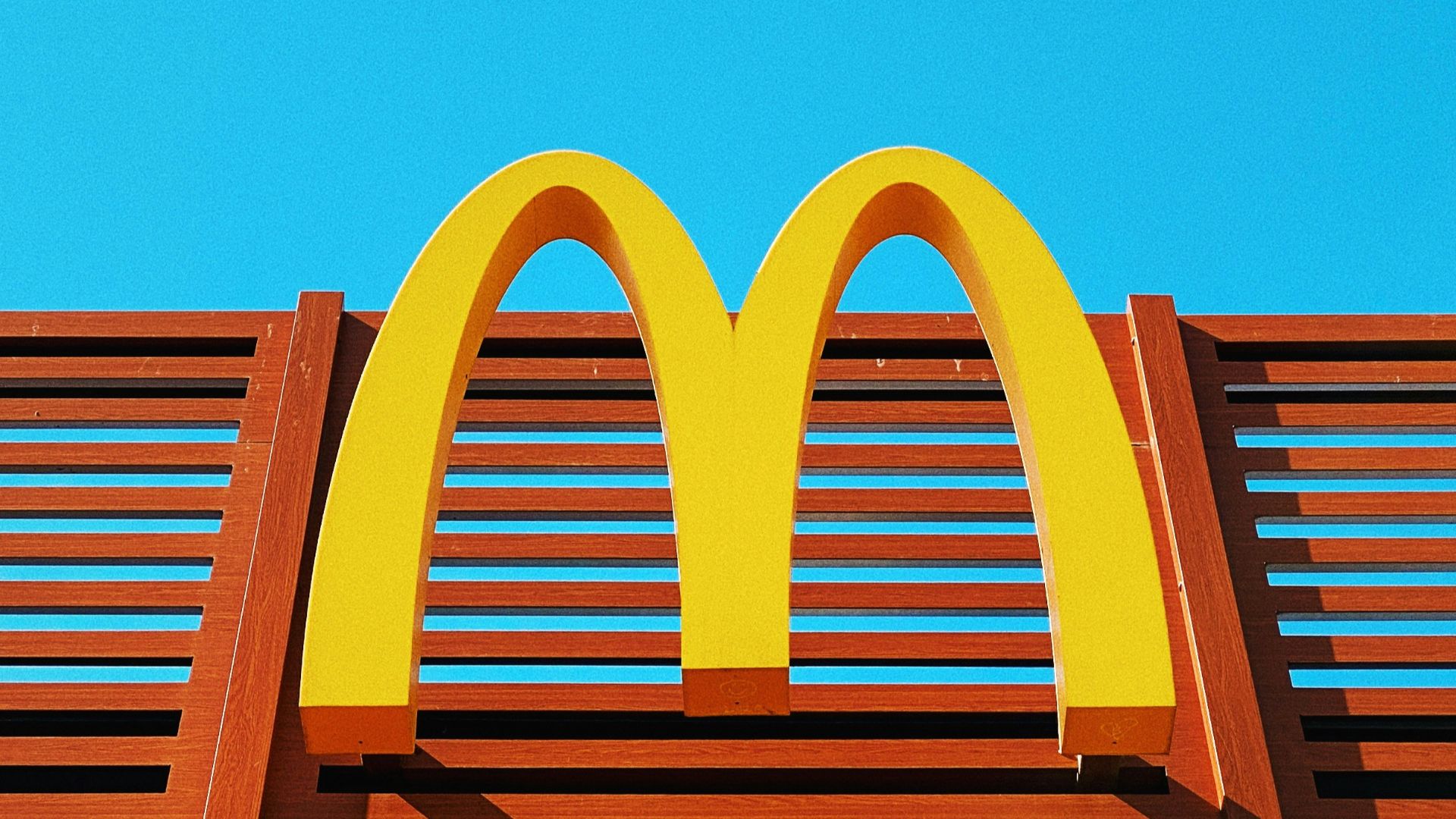 a wooden bench with a mcdonald's logo on it