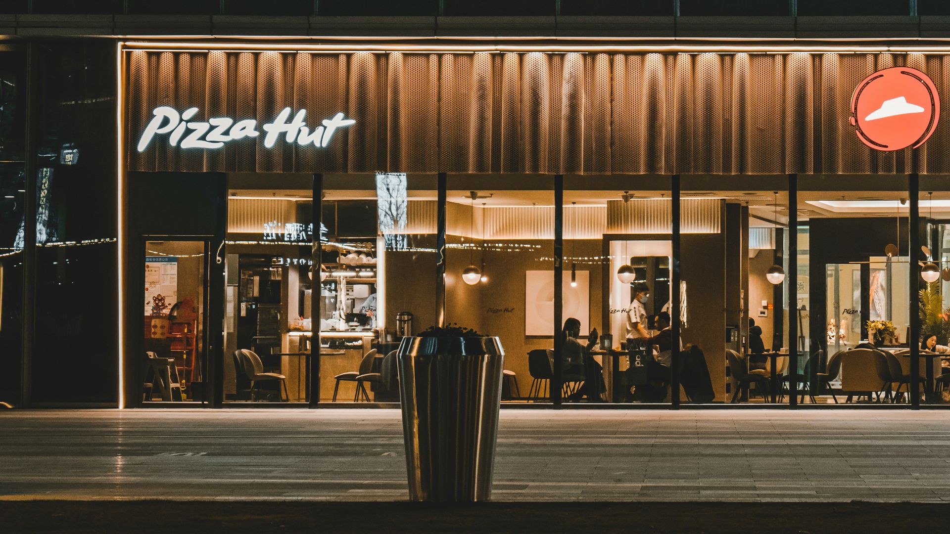 a building with a pizza hut lit up at night