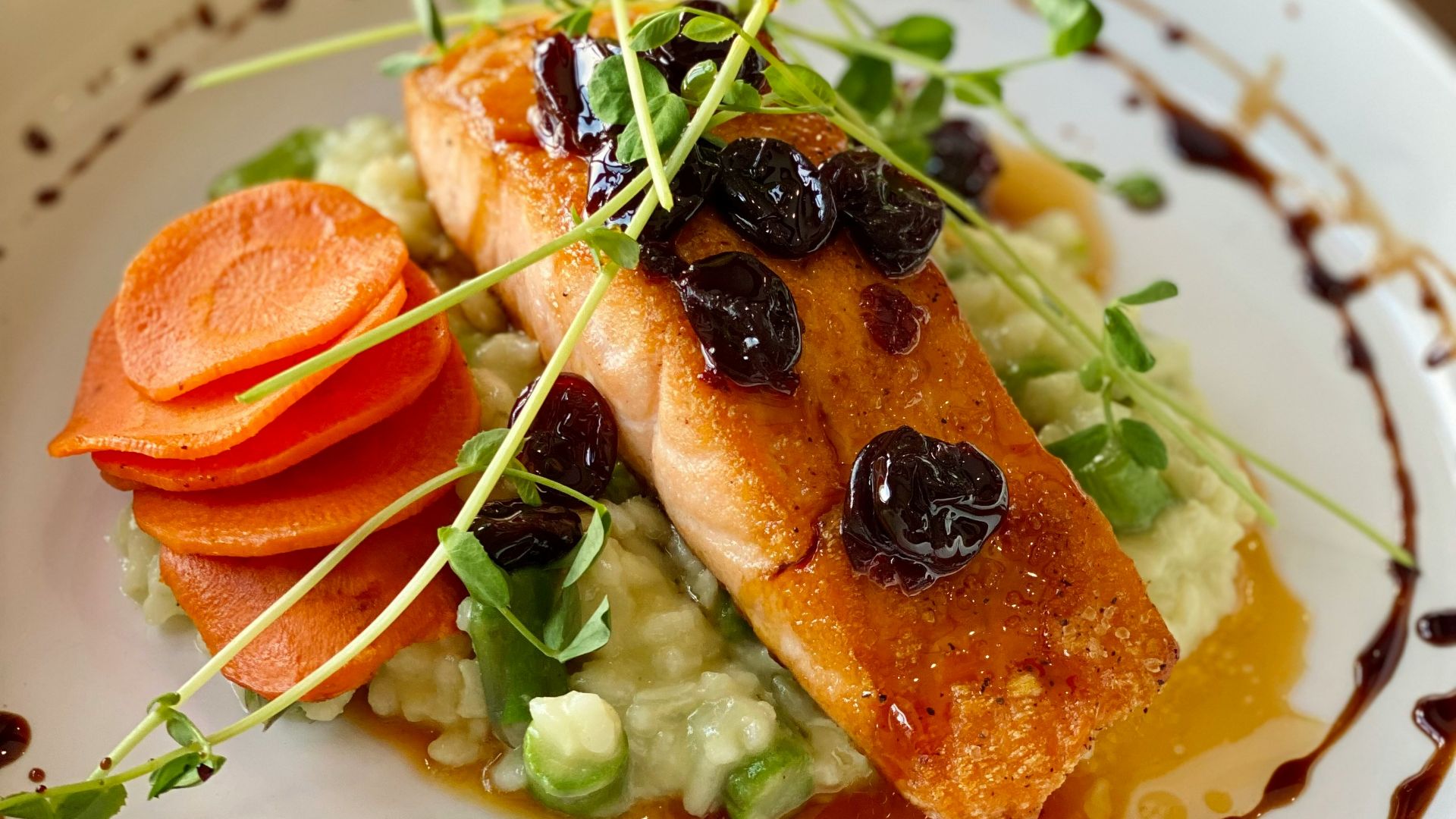 a white plate topped with fish and veggies