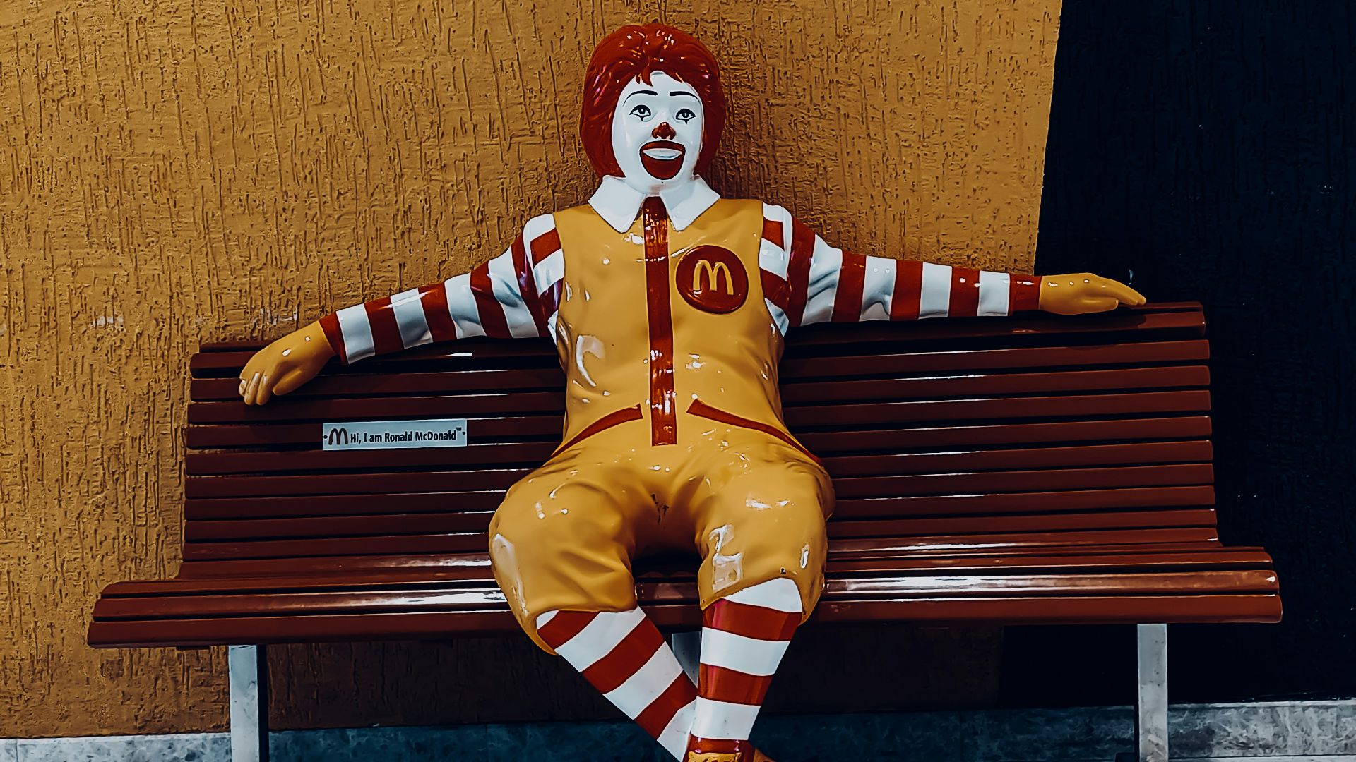 a clown sitting on a bench