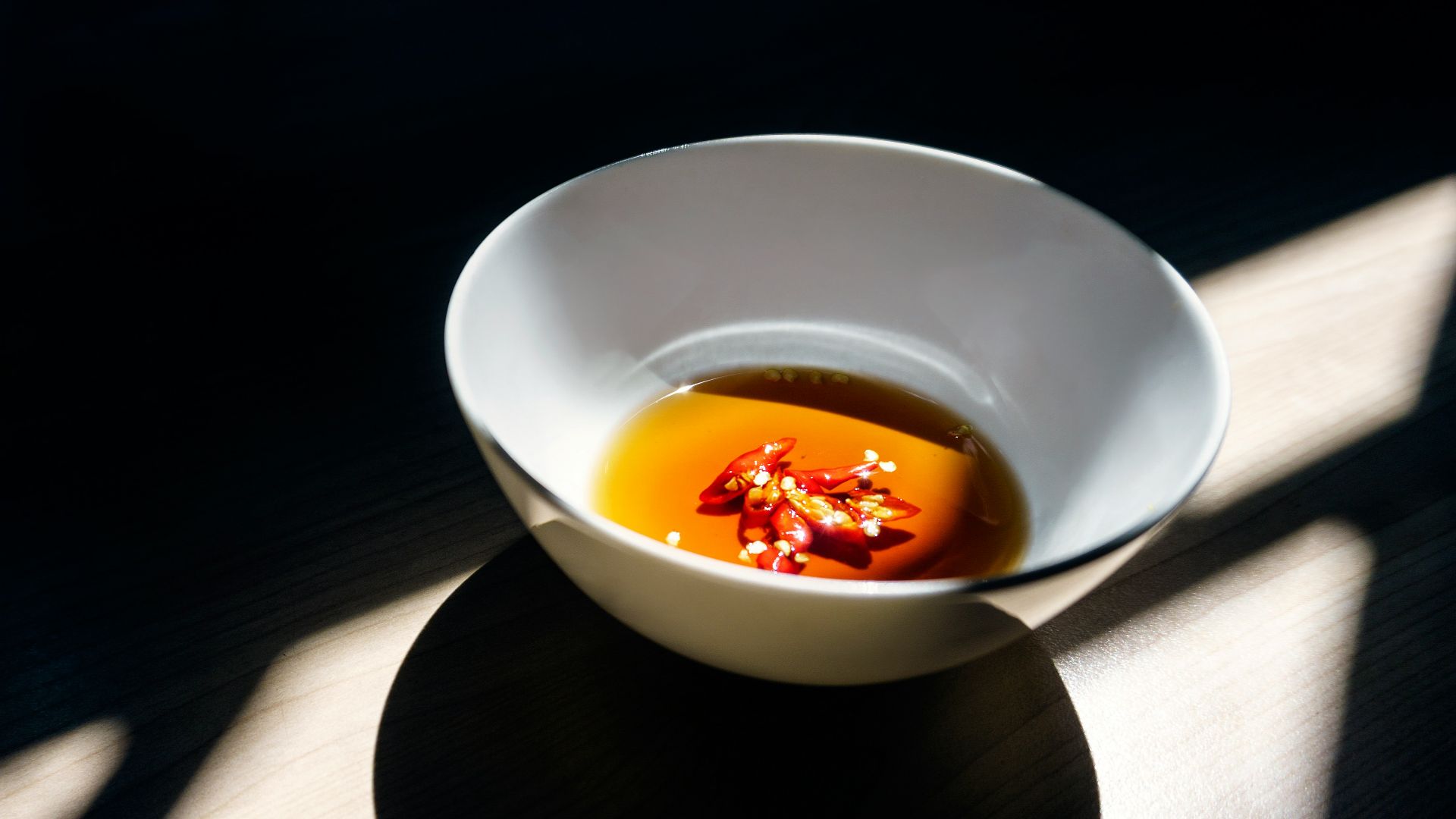 white ceramic bowl on wooden surface