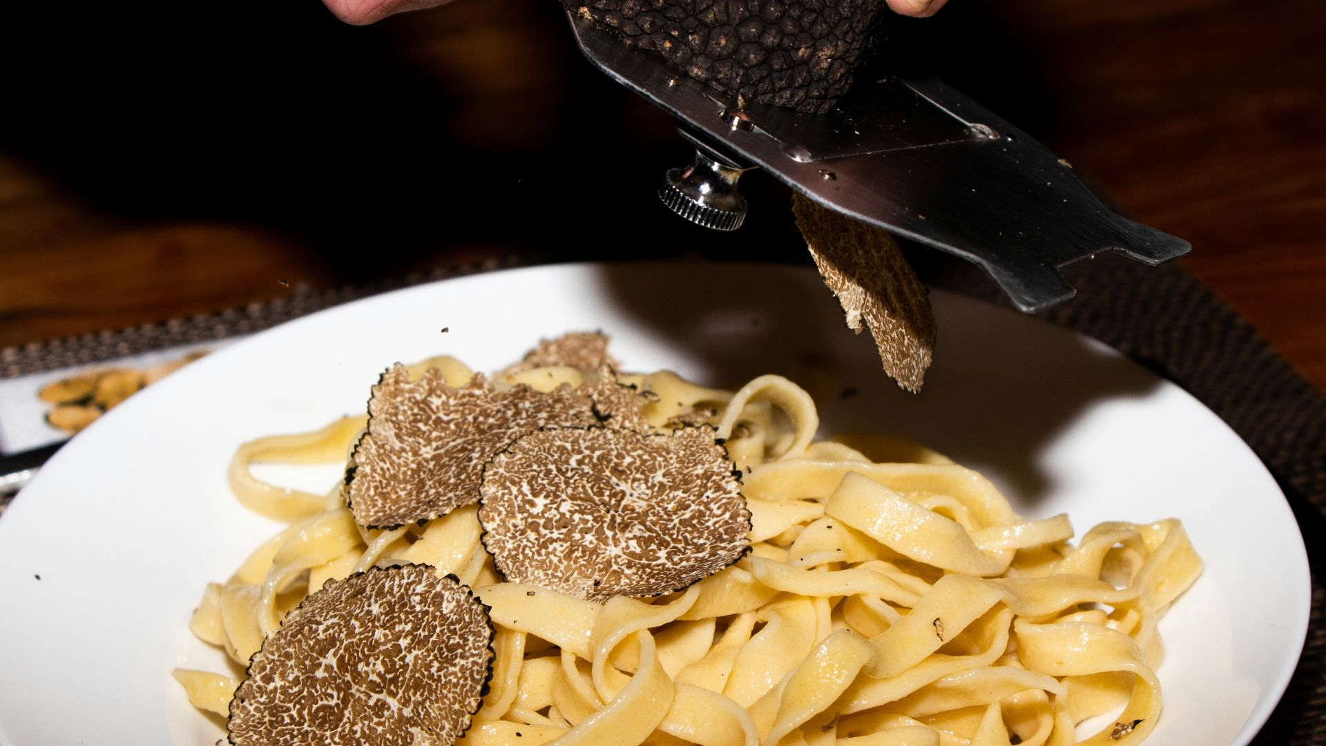 a plate of pasta with meatballs and a knife