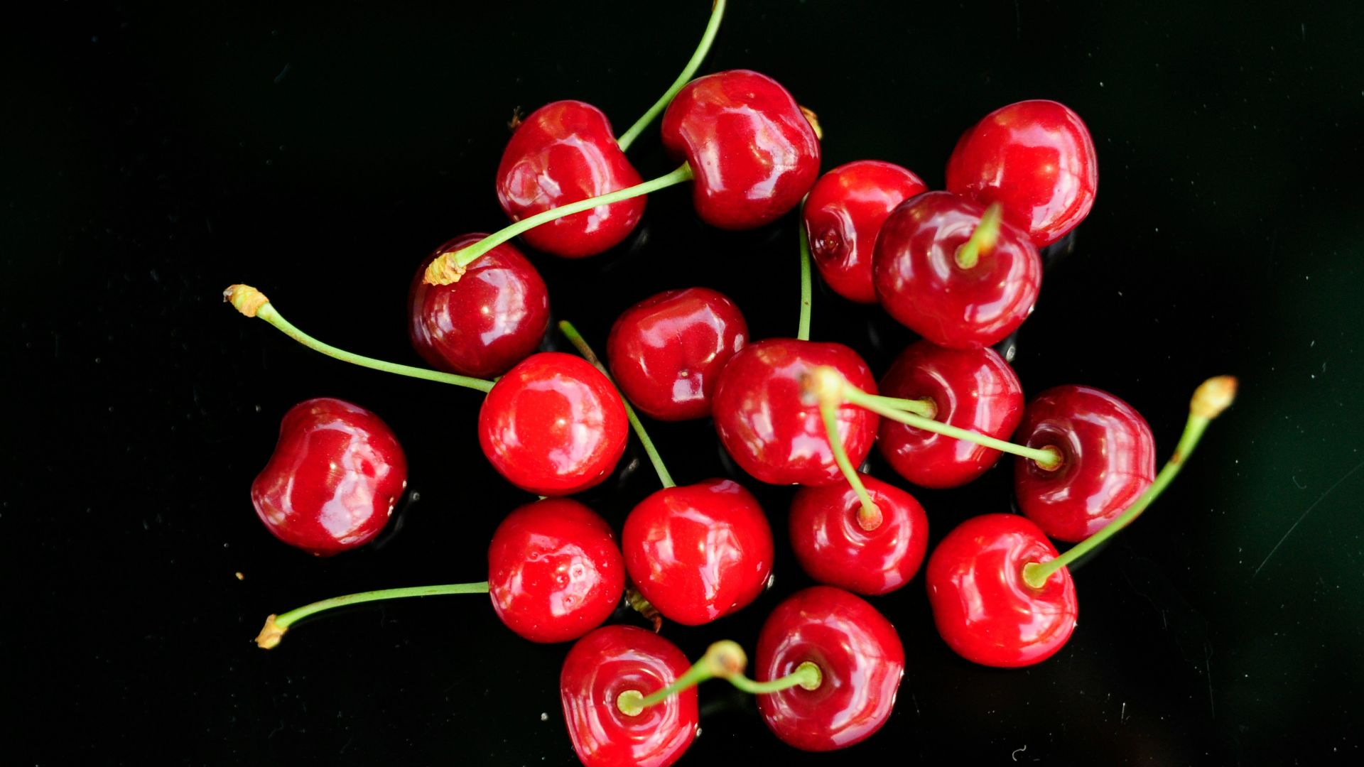 a bunch of red cherries sitting on top of a table