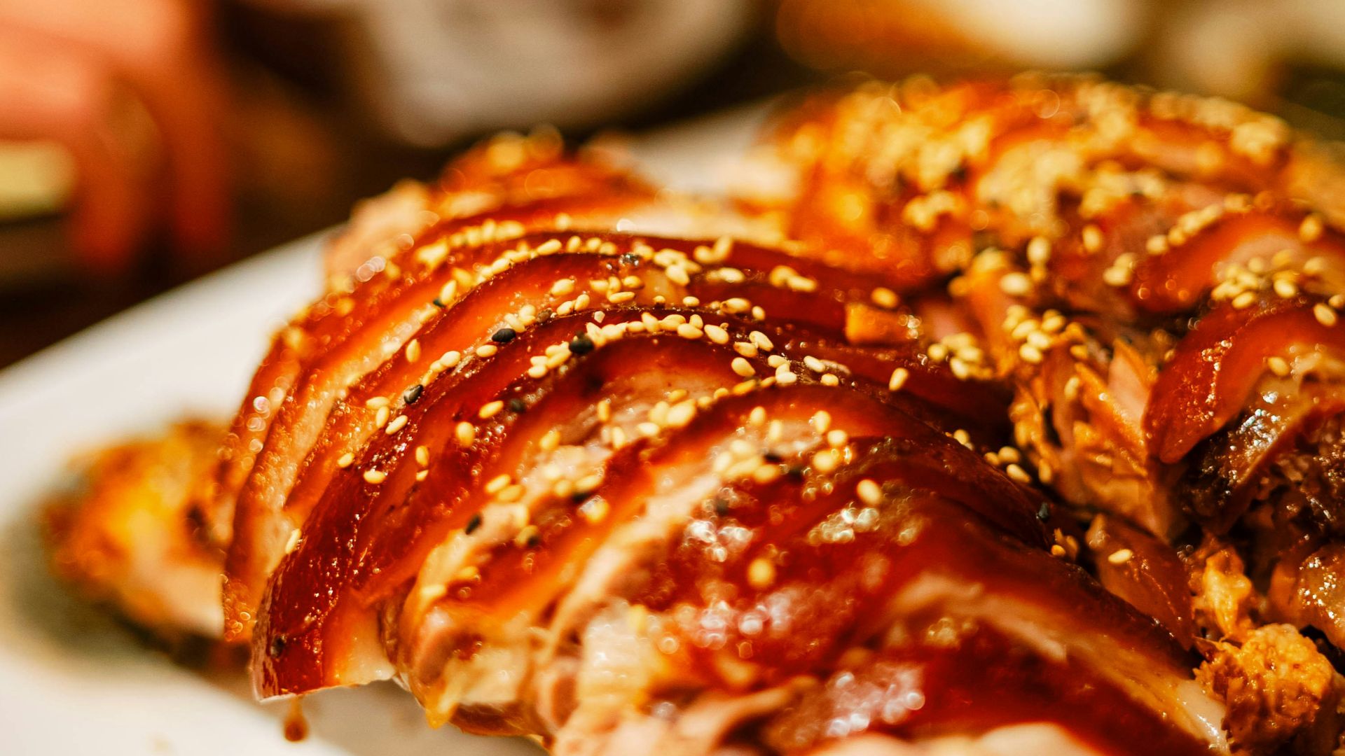 Delicious pork belly with sesame seeds is on a plate.