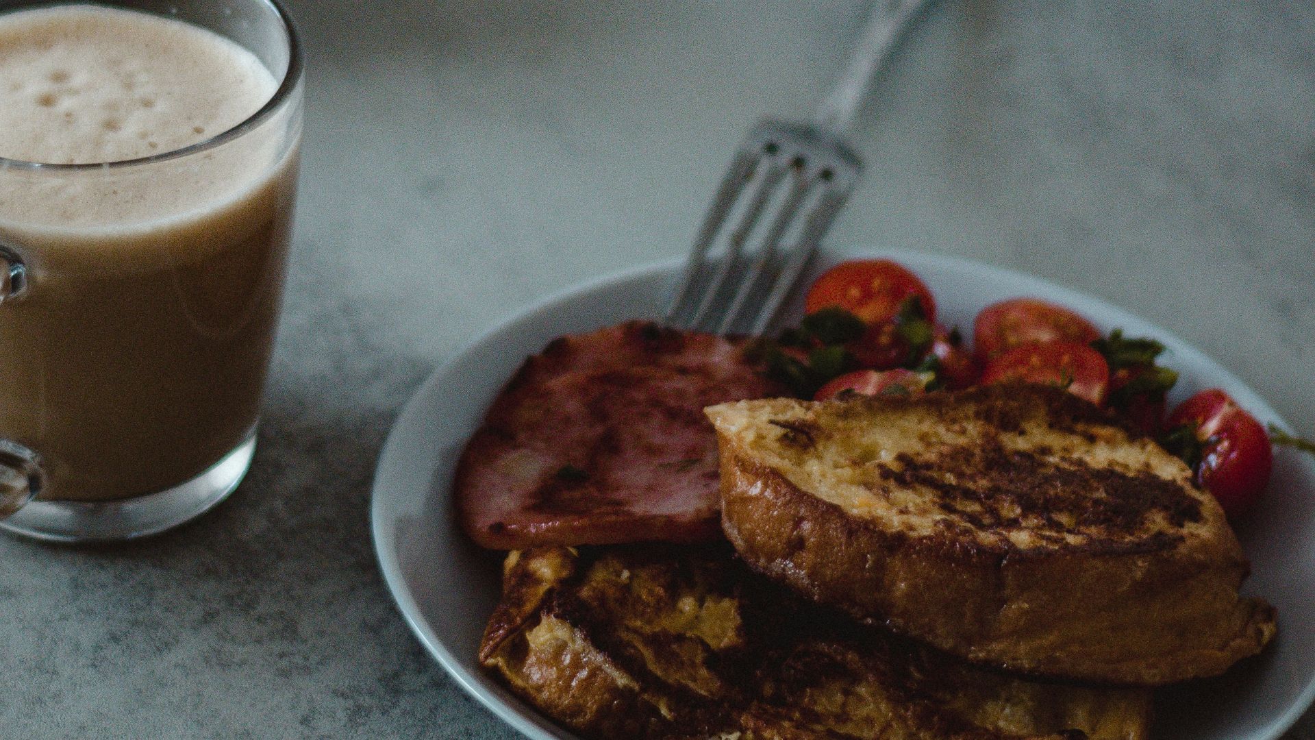 a plate of food and a cup of coffee on a table