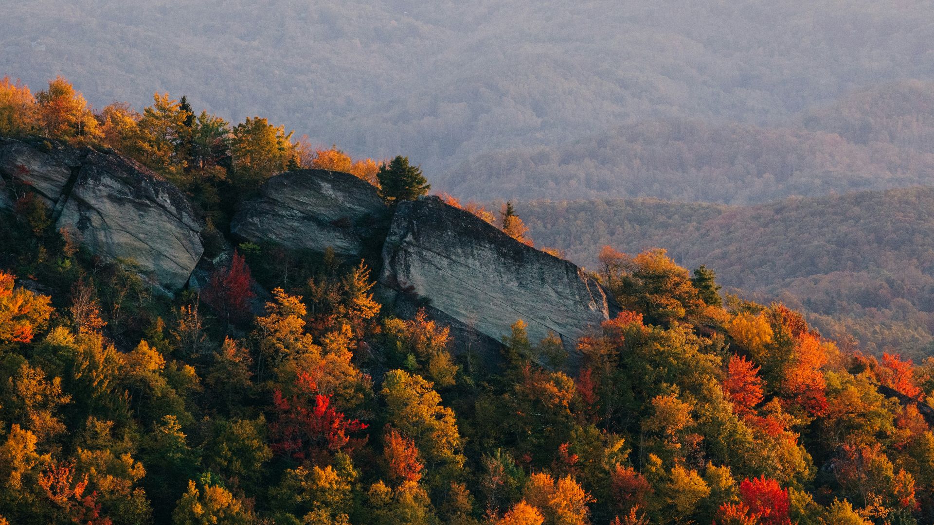 a scenic view of a mountain range in the fall