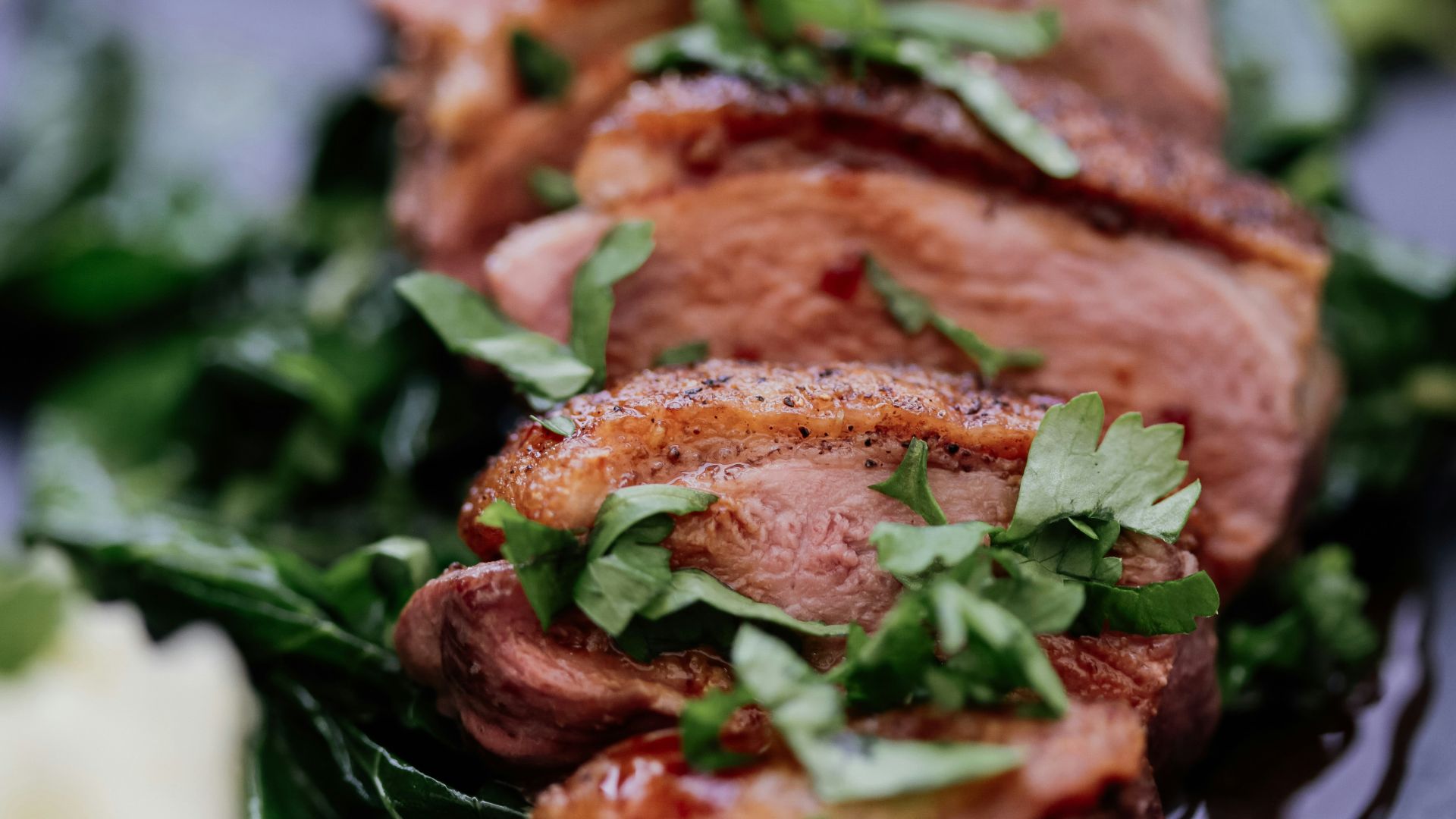 grilled meat with green vegetable on white ceramic plate