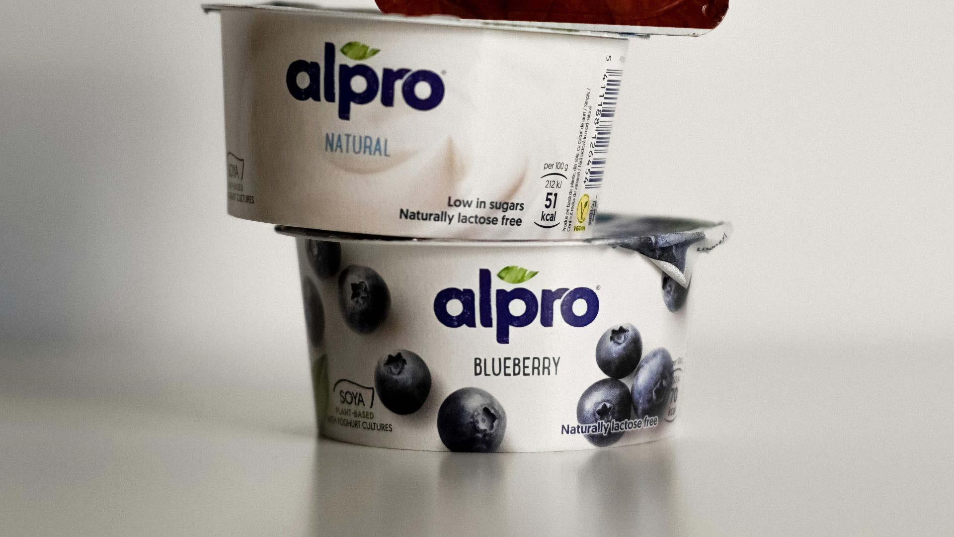 two cups of ice cream and a bag of chocolate