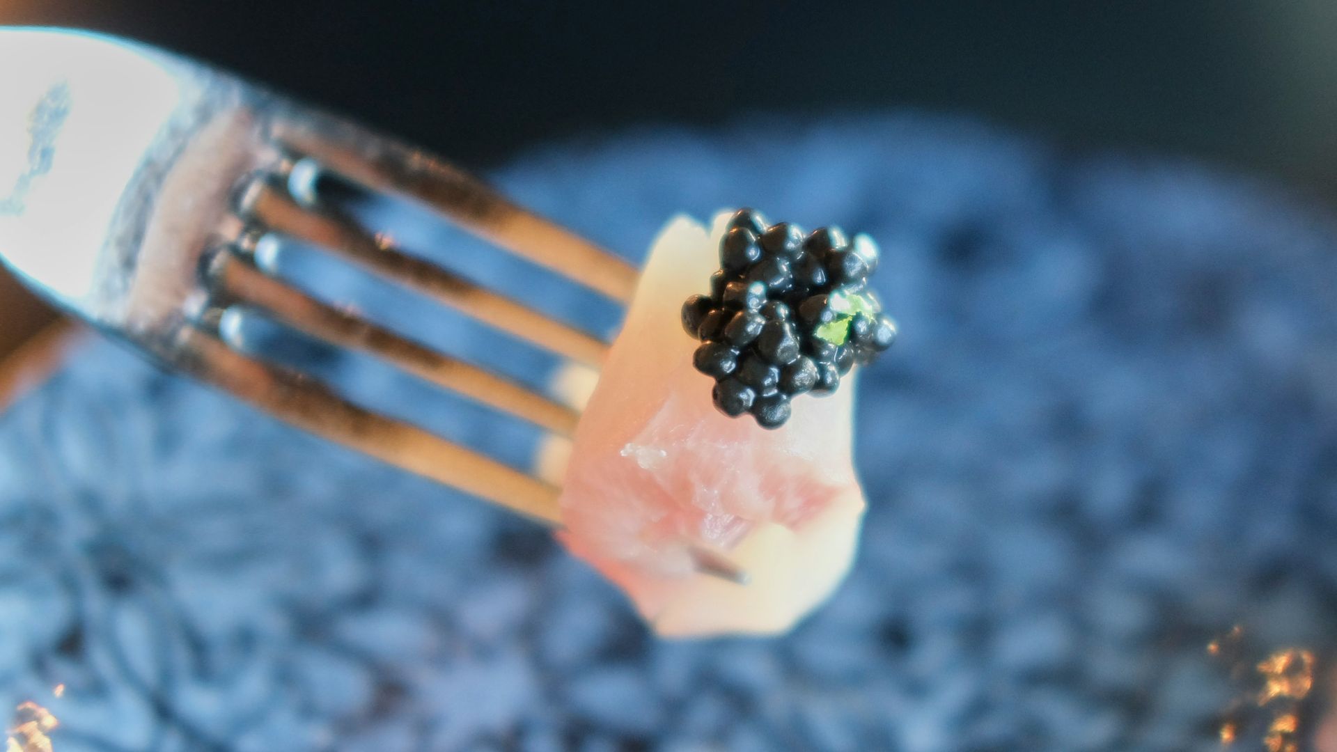 a fork with a piece of fruit on top of it