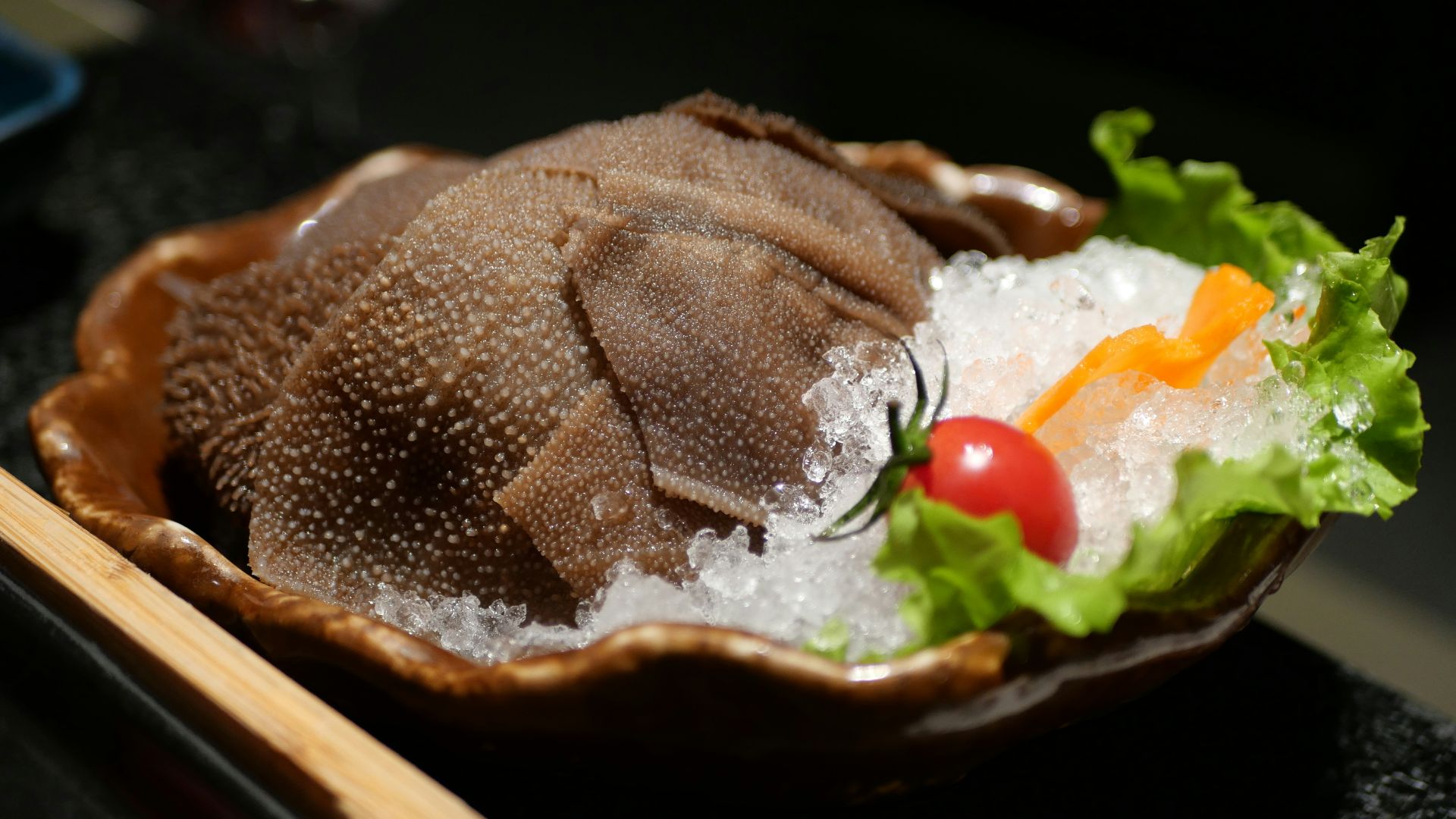 A bowl of food on a table with chopsticks
