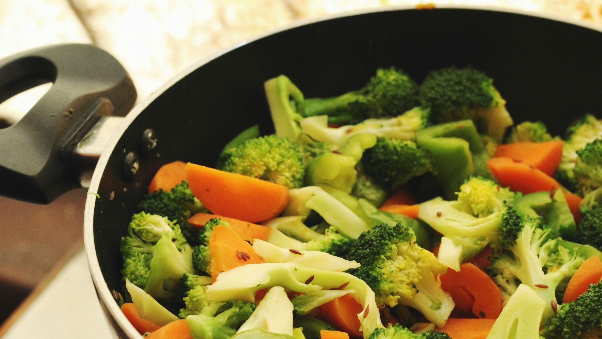 green and orange vegetable salad in white ceramic bowl