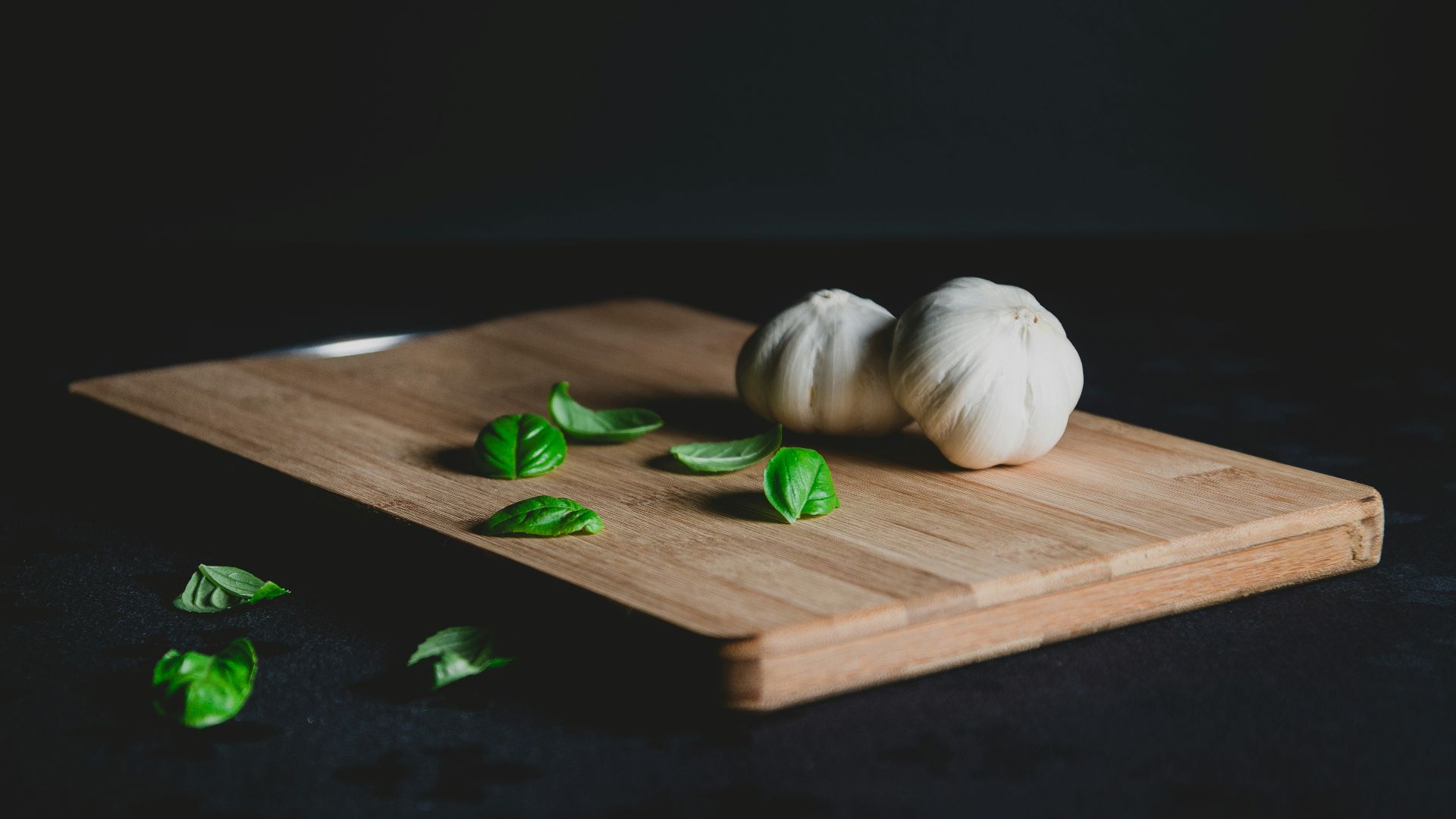 two bulb of garlic on top of chopping board