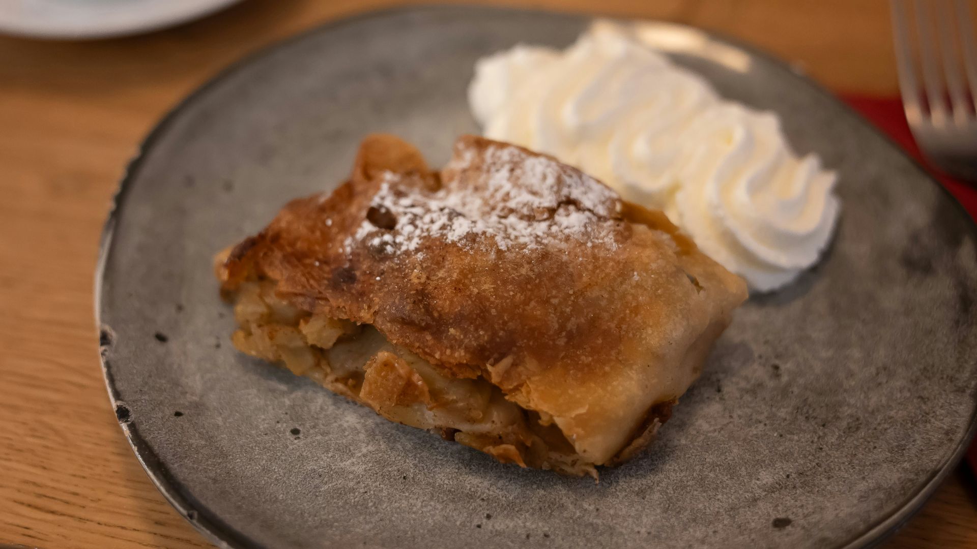 A piece of pie and whipped cream on a plate