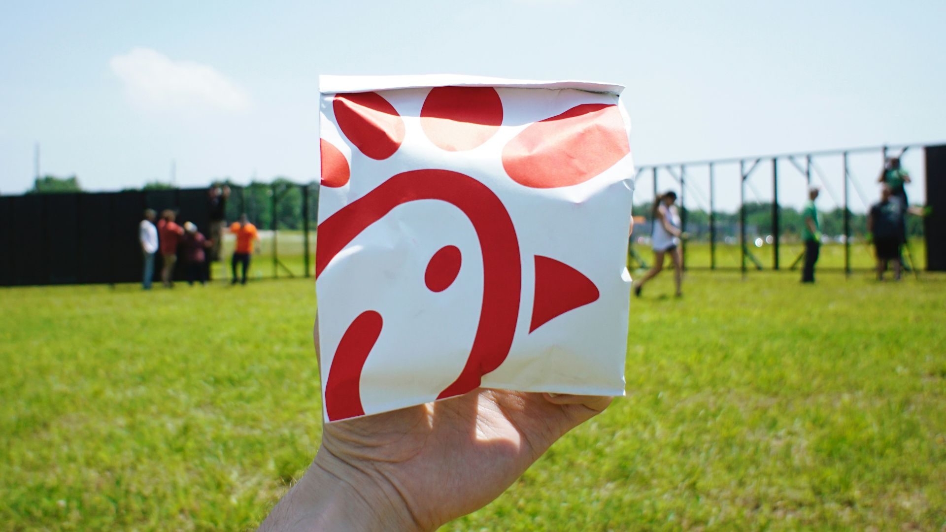person holding white and red box
