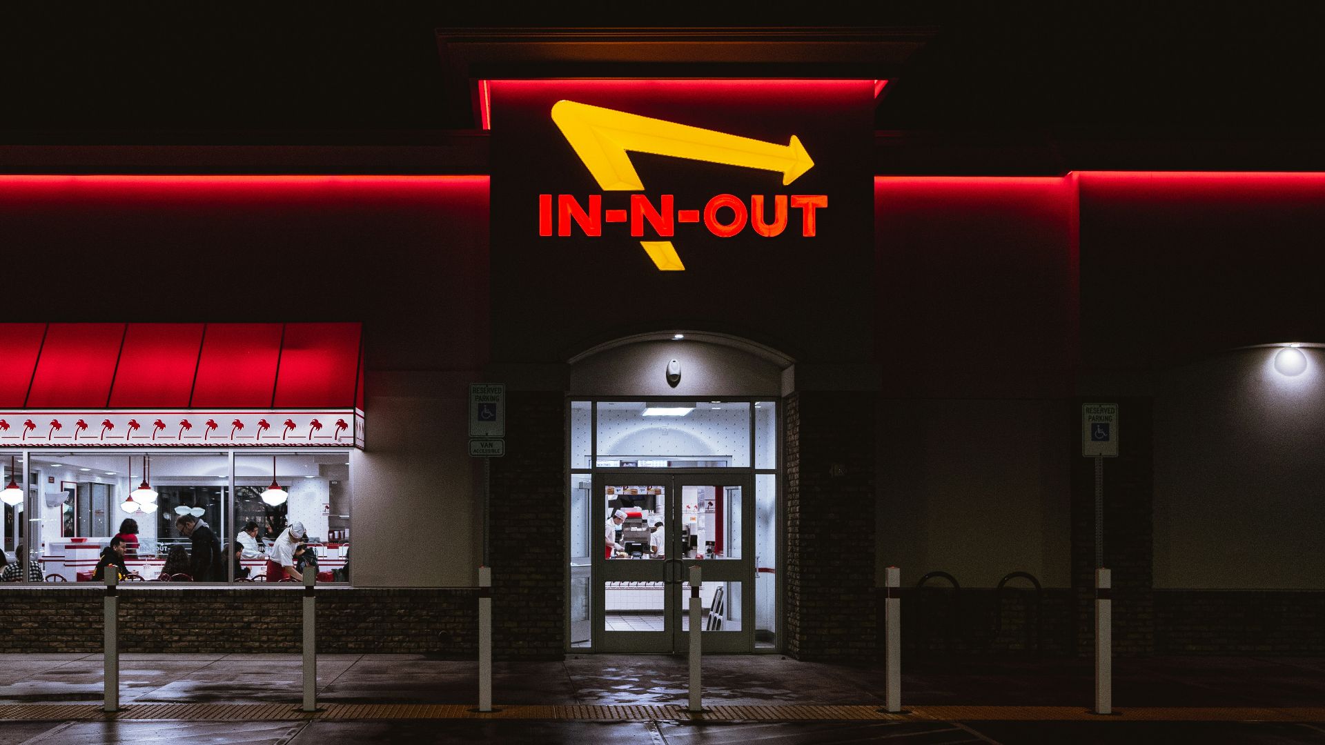 an in - n - out store lit up at night
