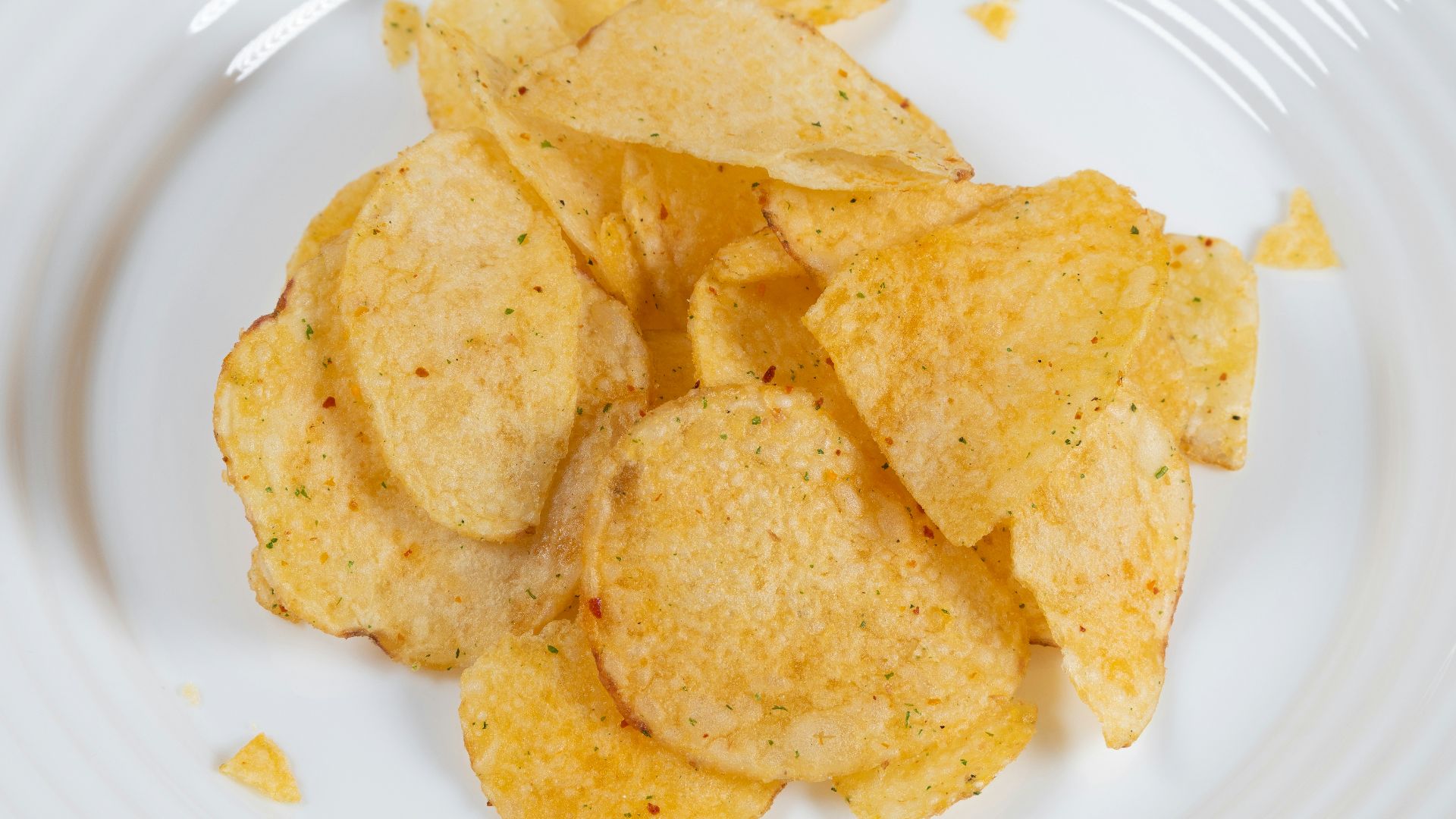 a white plate topped with chips on top of a table