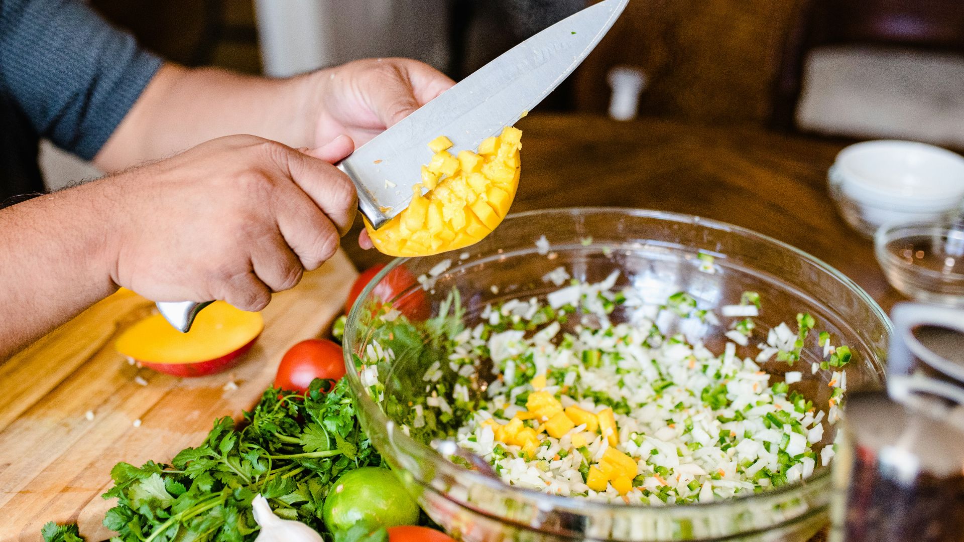 a person cutting up vegetables on a cutting board
