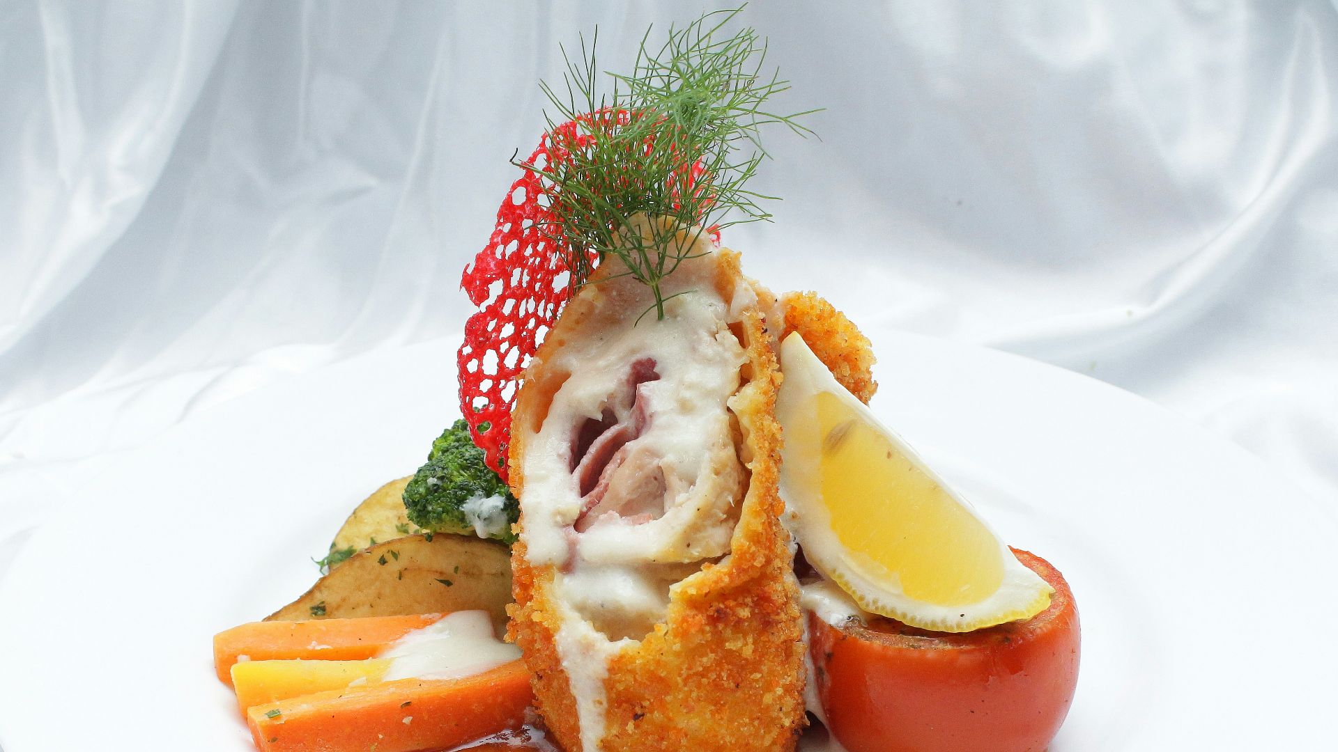 a white plate topped with meat and vegetables