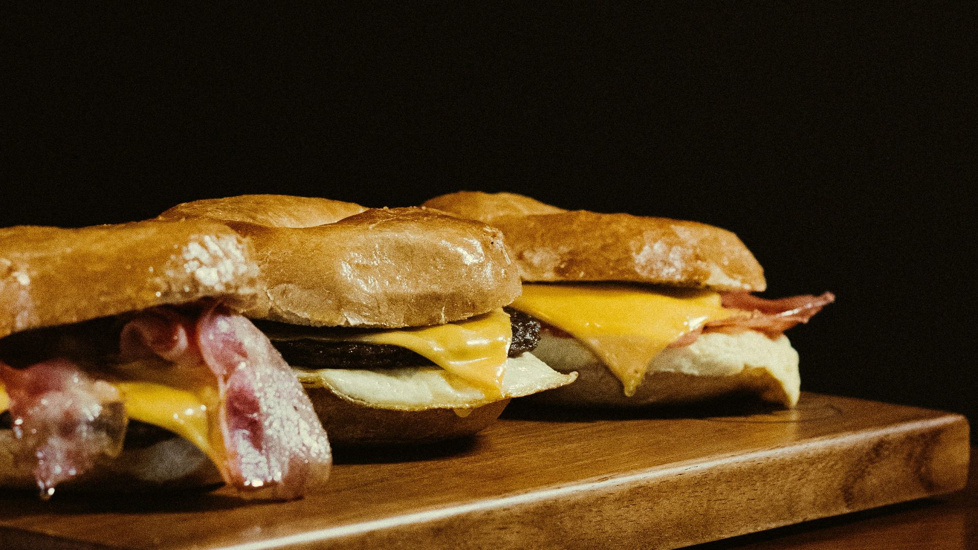 a wooden cutting board topped with a sandwich