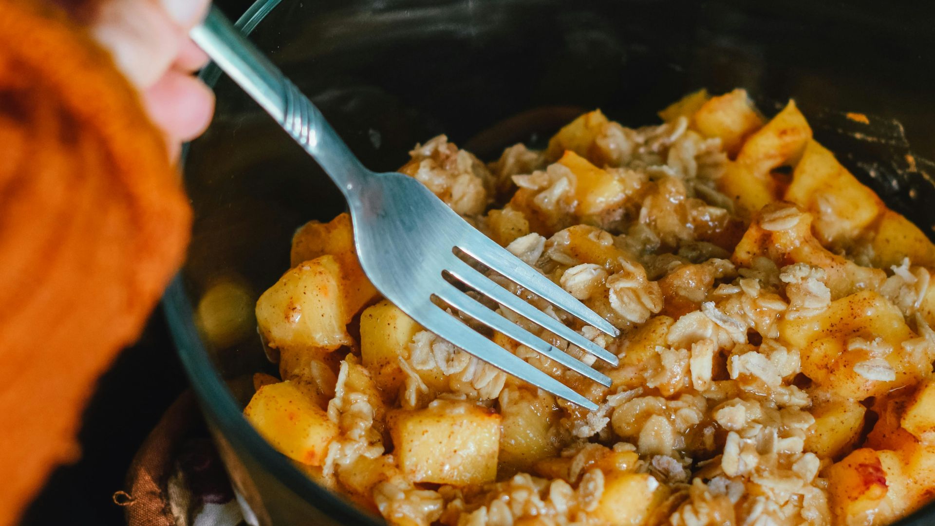person holding fork getting food