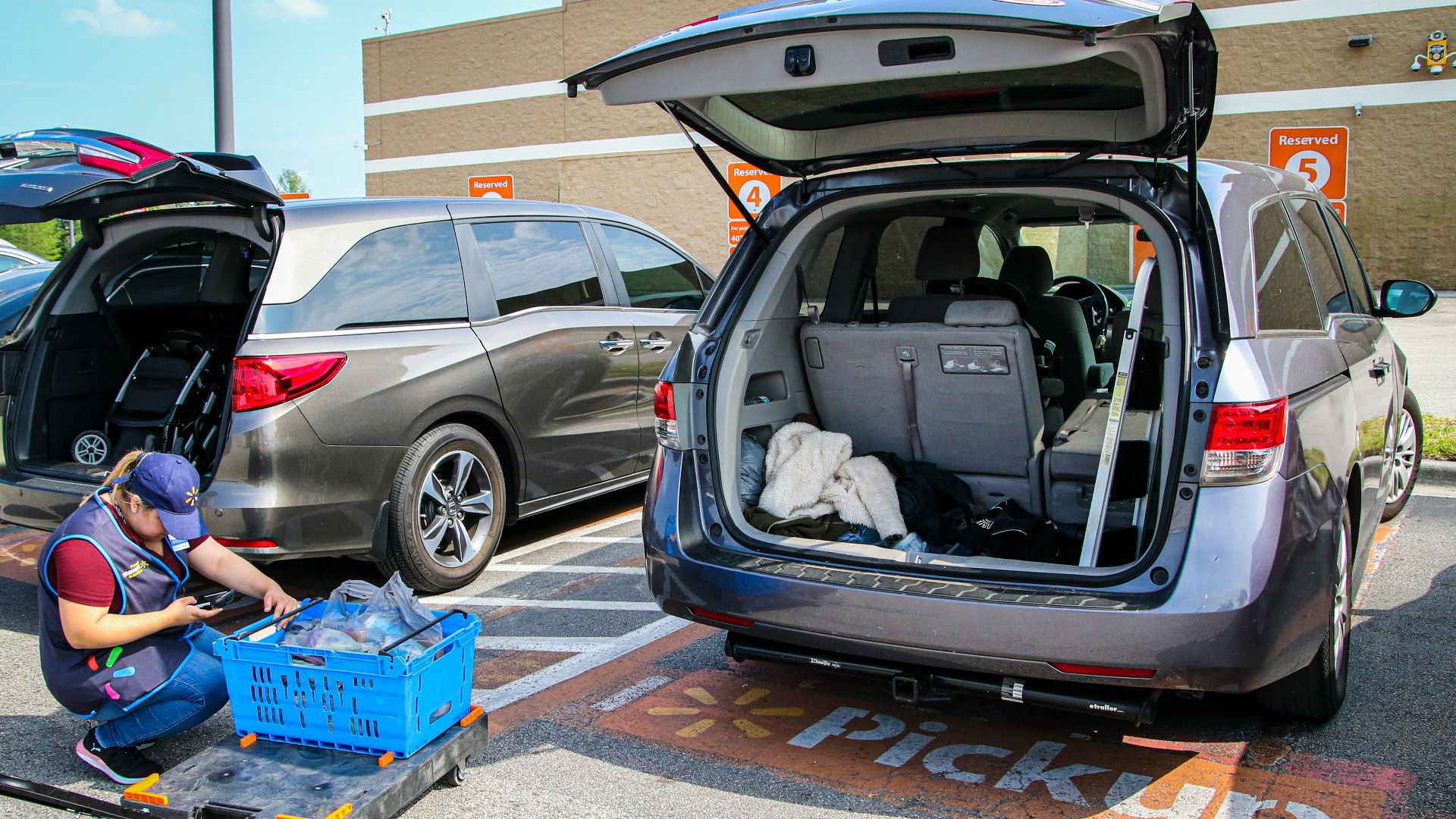 silver suv with blue plastic crate