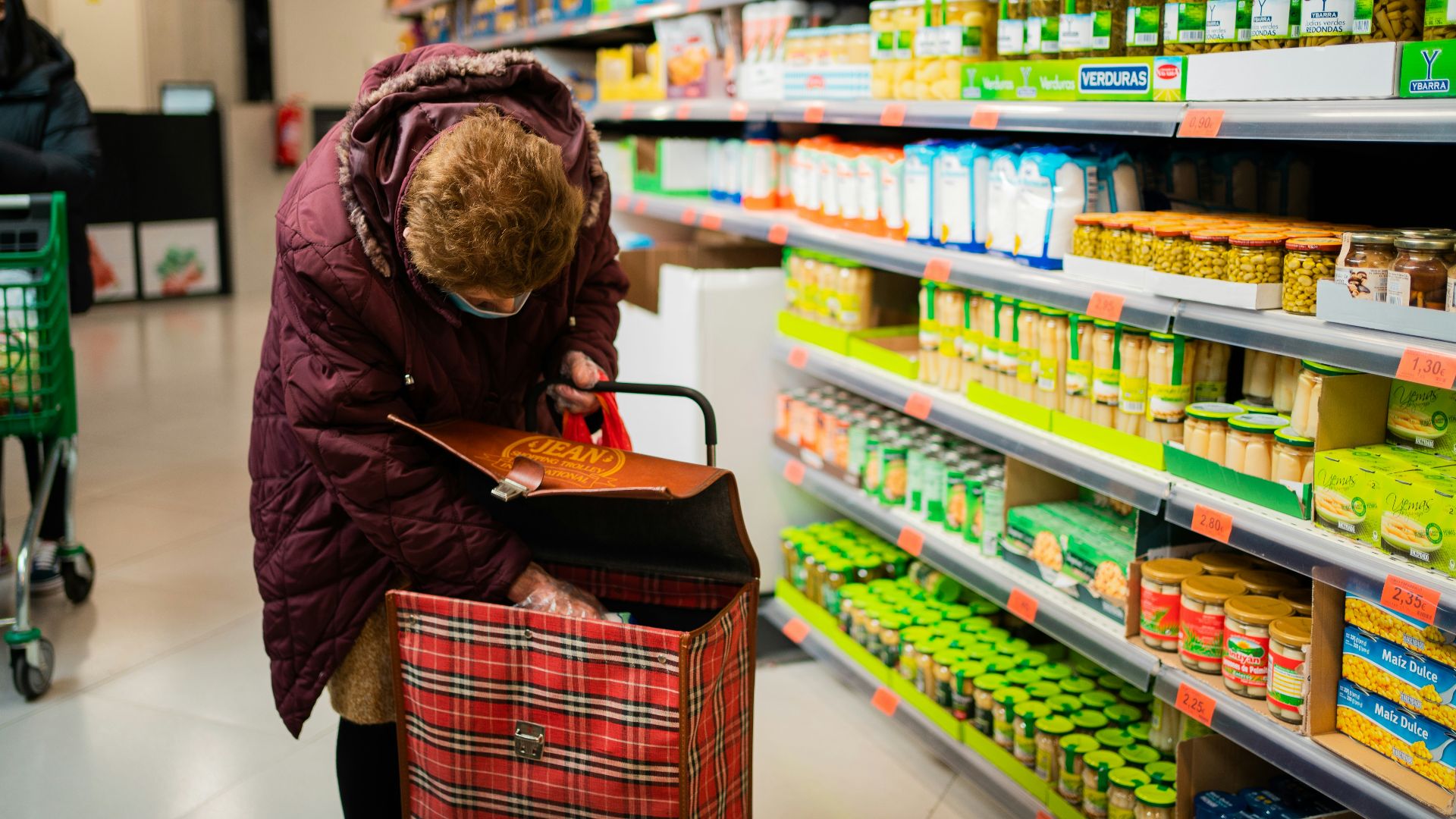 woman in brown leather jacket holding brown leather handbag