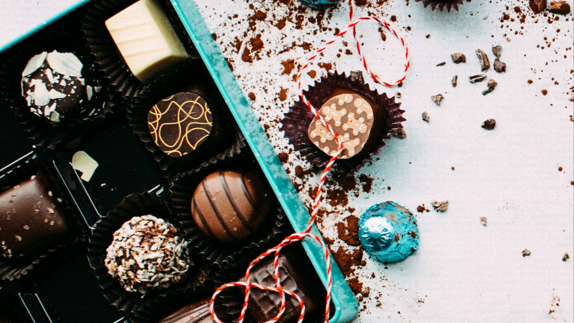 chocolates with box on white surface