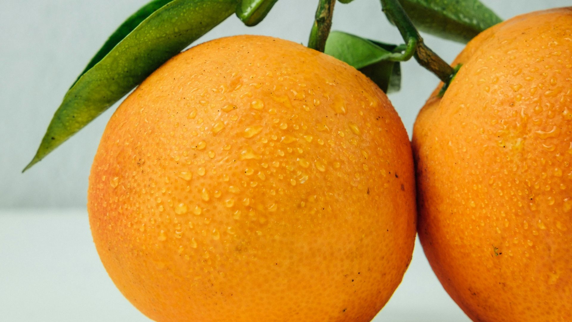 two orange fruits on table