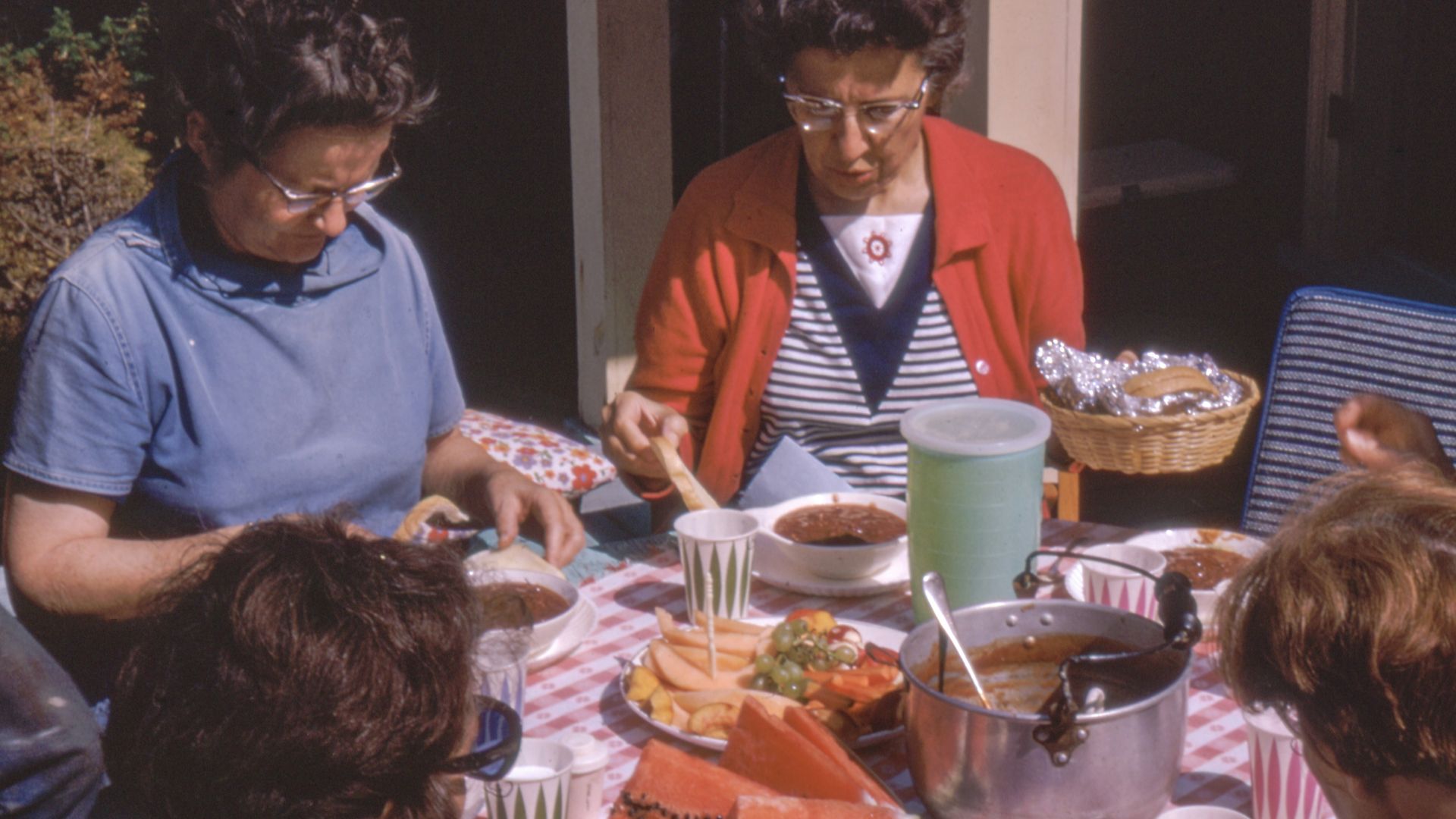 women sitting beside table
