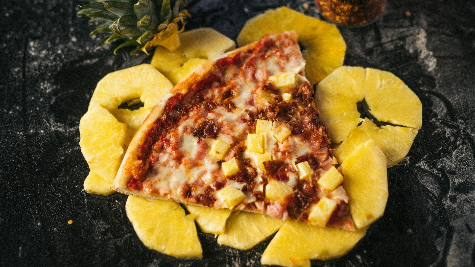a piece of pizza with pineapple on top of it