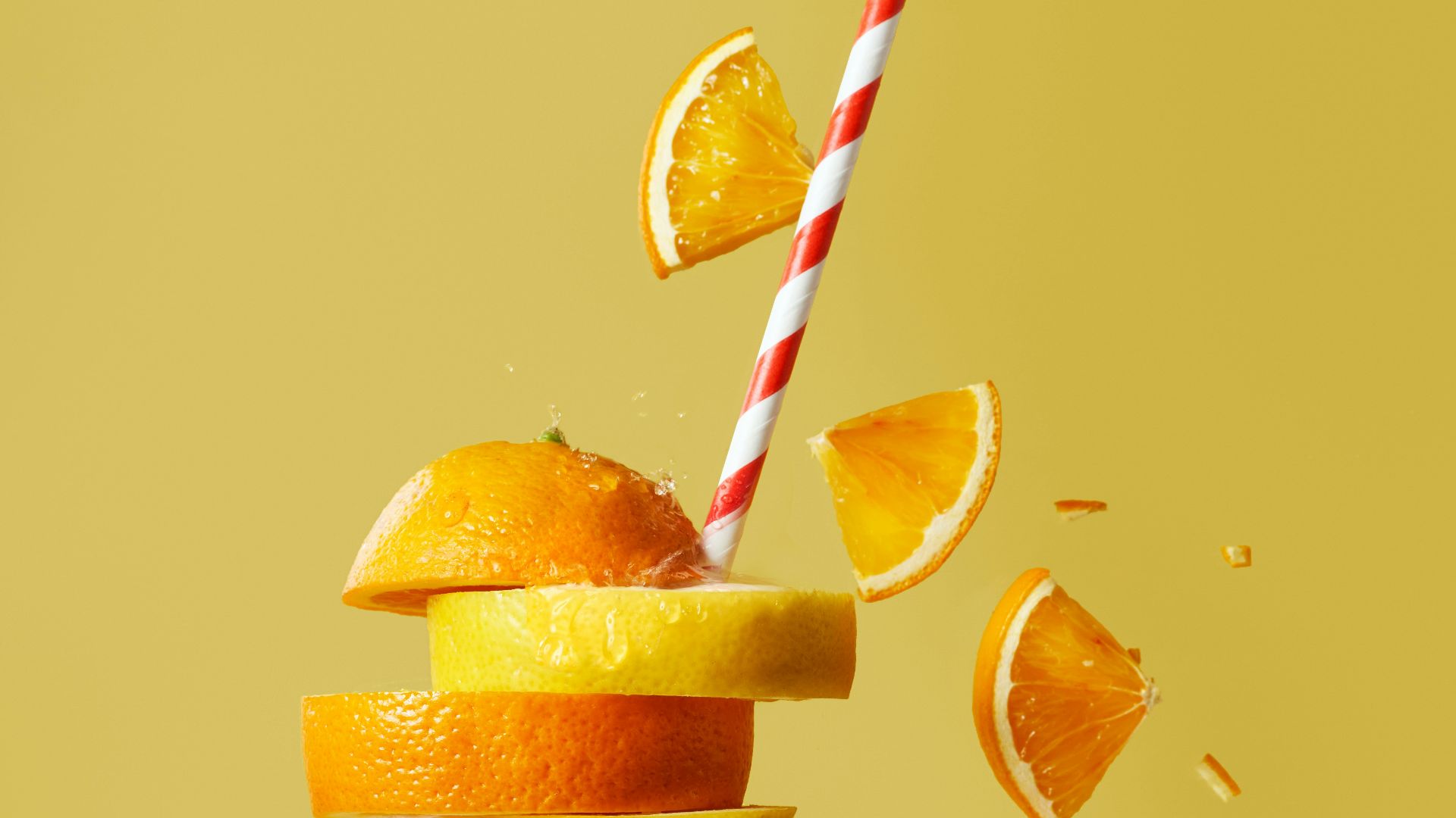 sliced orange fruit with straw