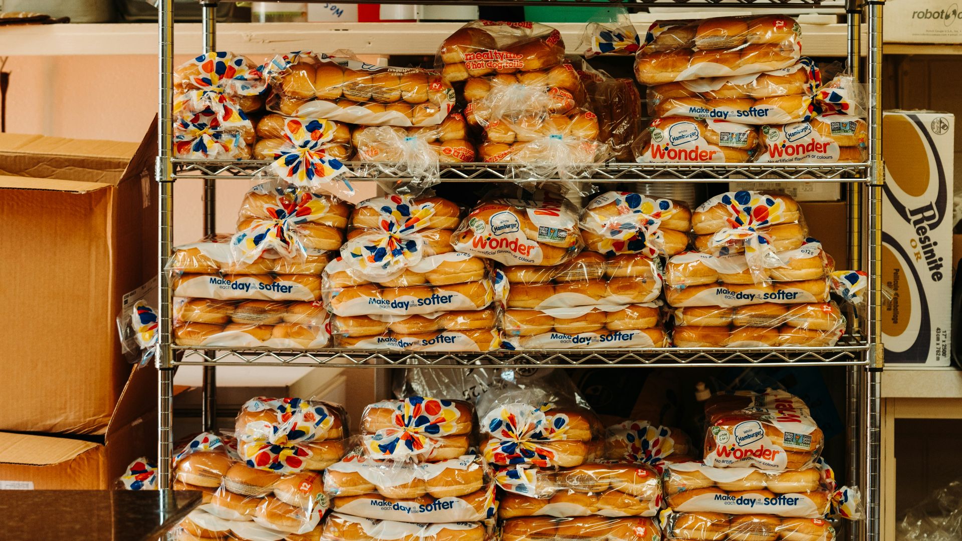 a shelf filled with lots of different kinds of bread