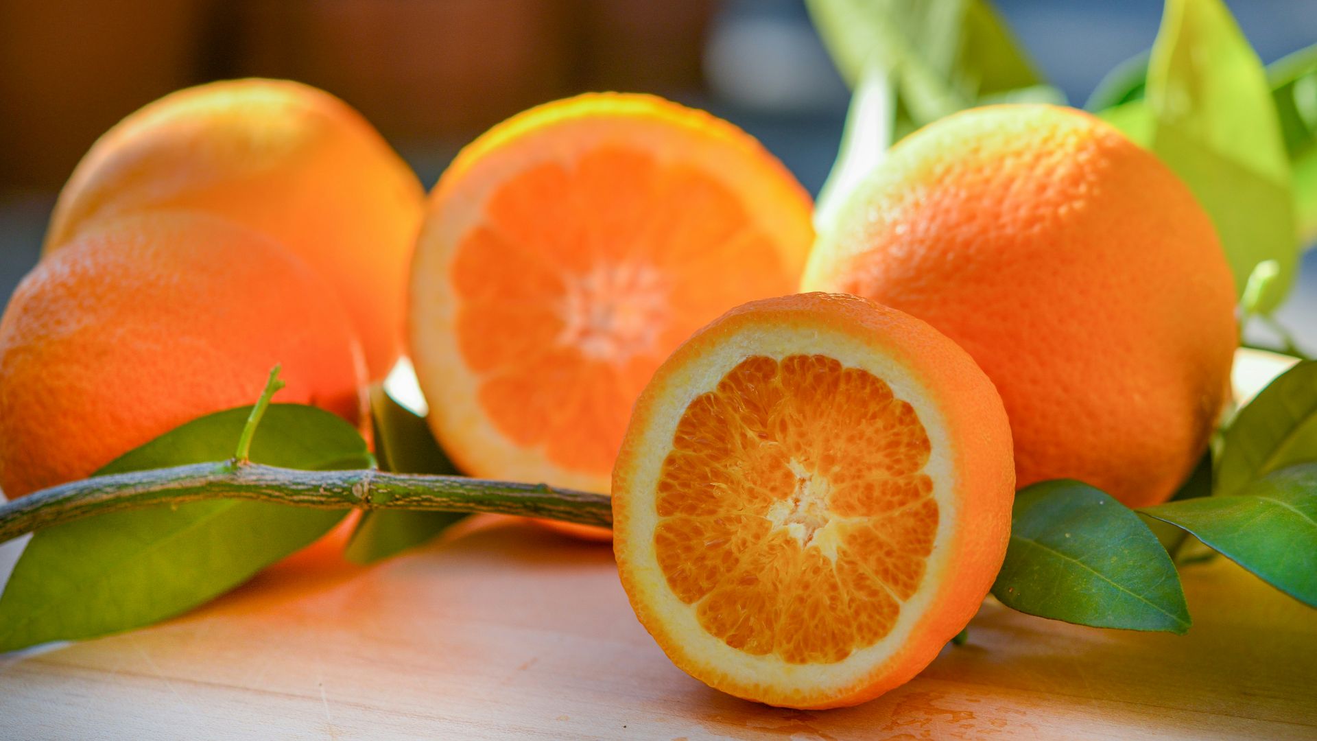 a group of oranges sitting on top of a wooden table
