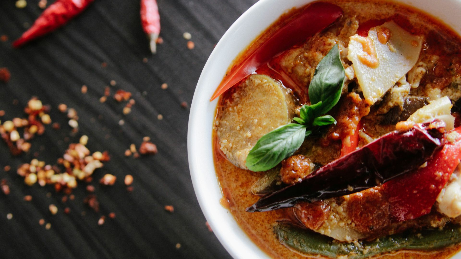 flat-lay photography of vegetable soup on white ceramic cup