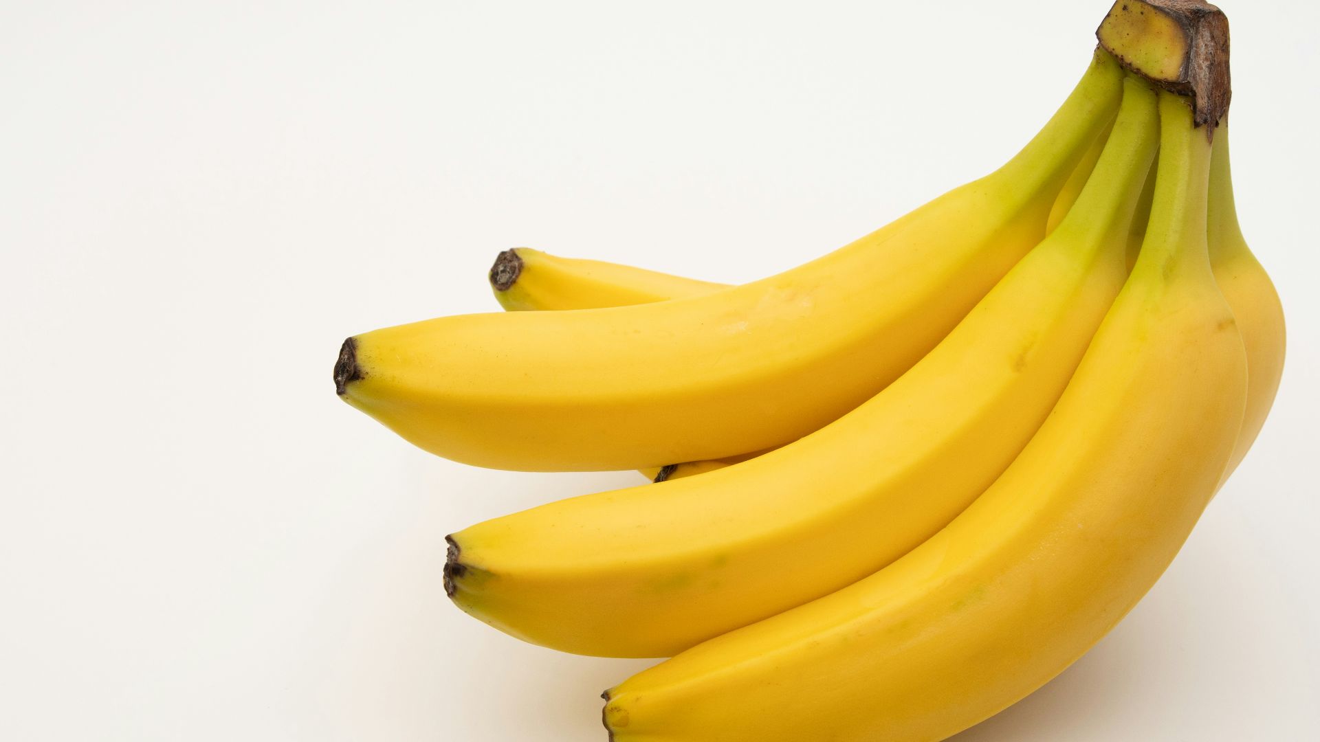 a bunch of bananas sitting on top of a white table
