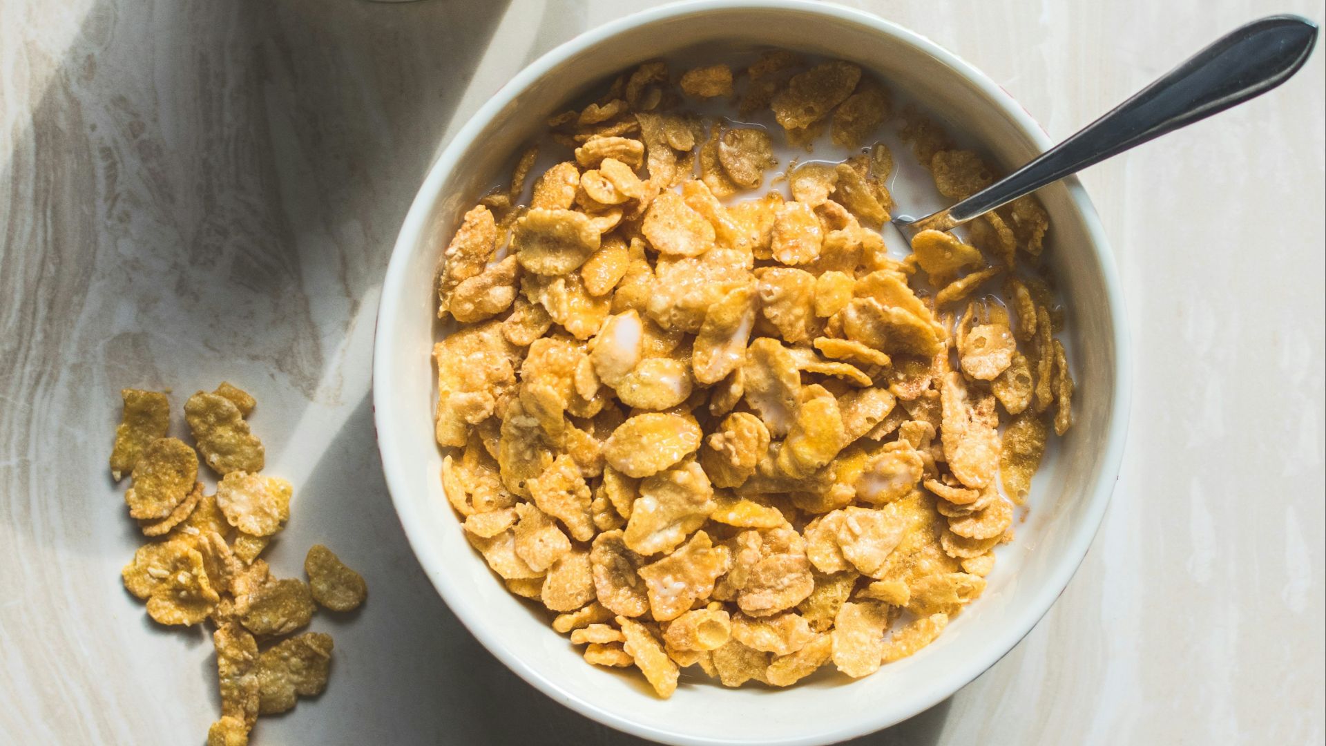 ceramic bowl filled with cereals and spoon