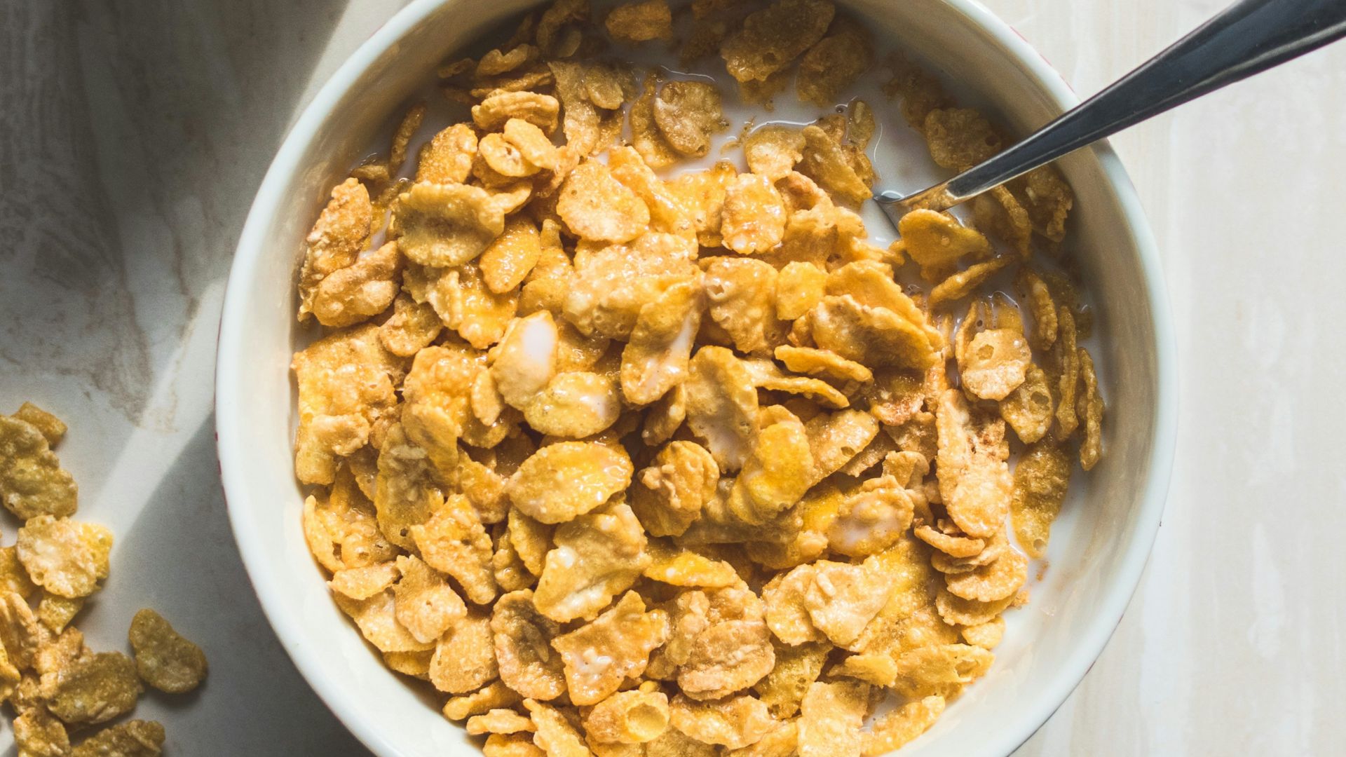ceramic bowl filled with cereals and spoon