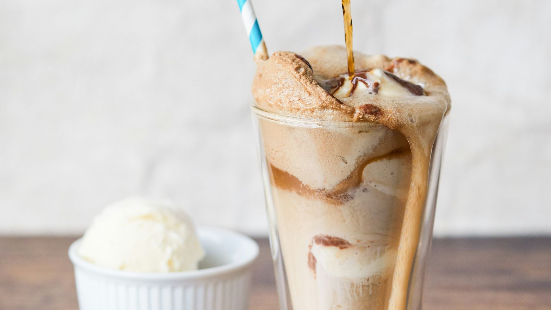 a person pours a beverage into a glass