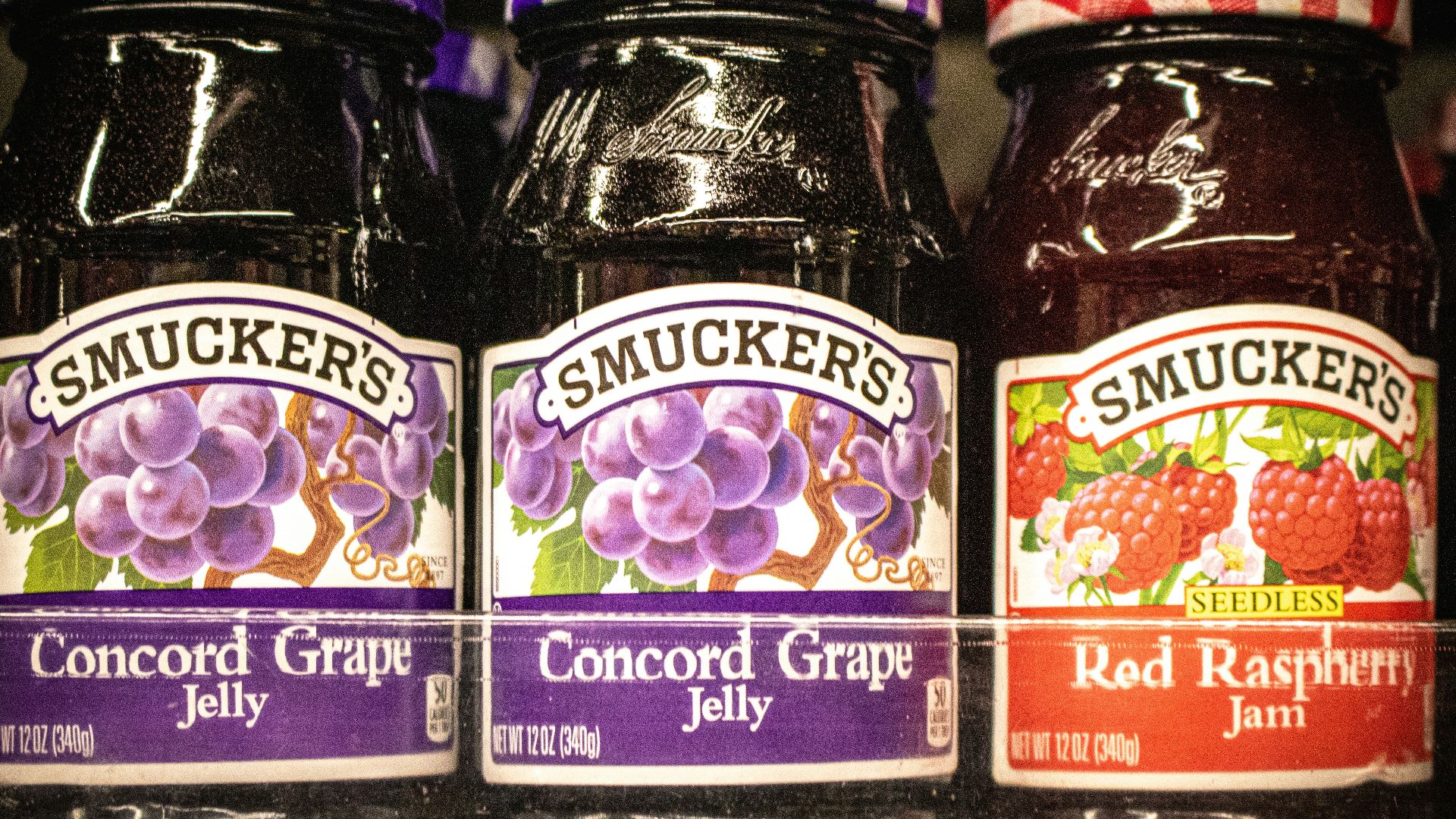 Smucker's grape jelly and raspberry jam.