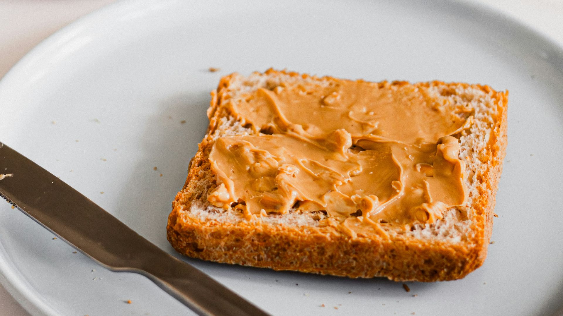 a piece of bread sitting on top of a white plate