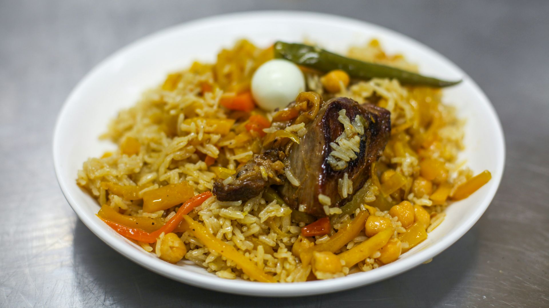 a white bowl filled with rice and vegetables