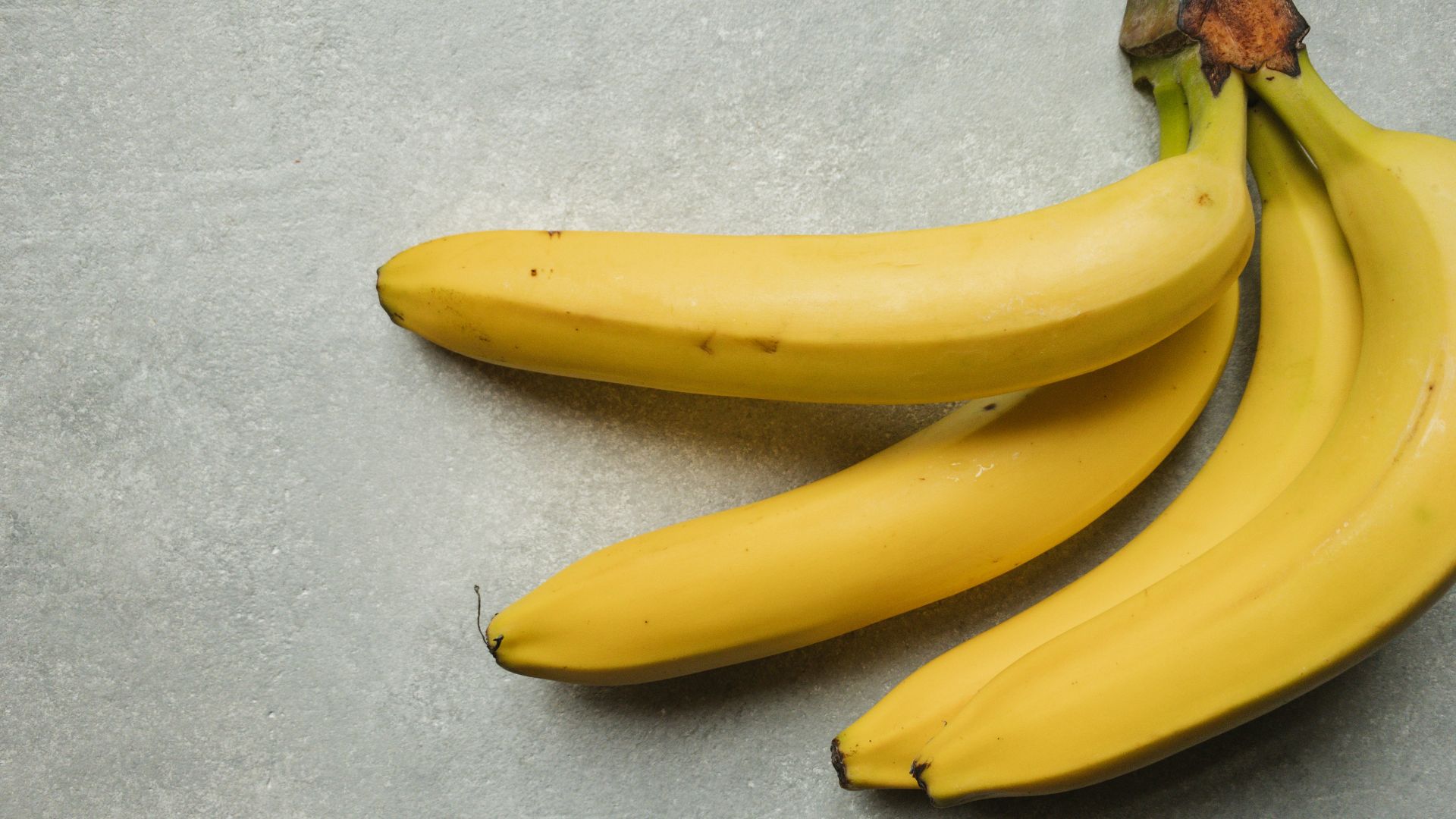 yellow banana fruit on gray table