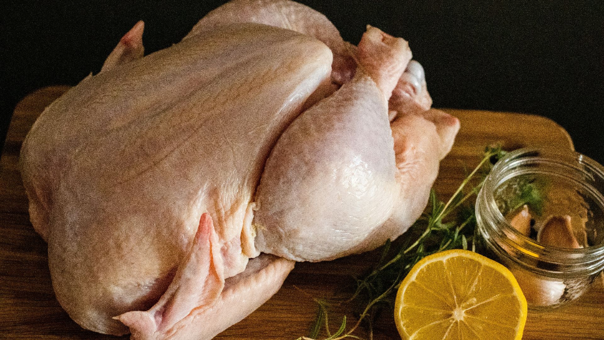 raw chicken meat on brown wooden chopping board