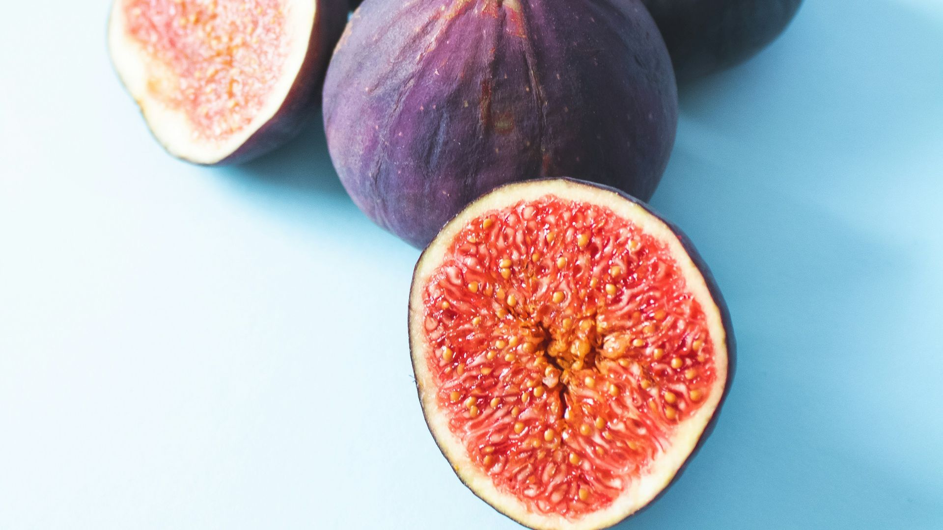 2 round black and red fruits