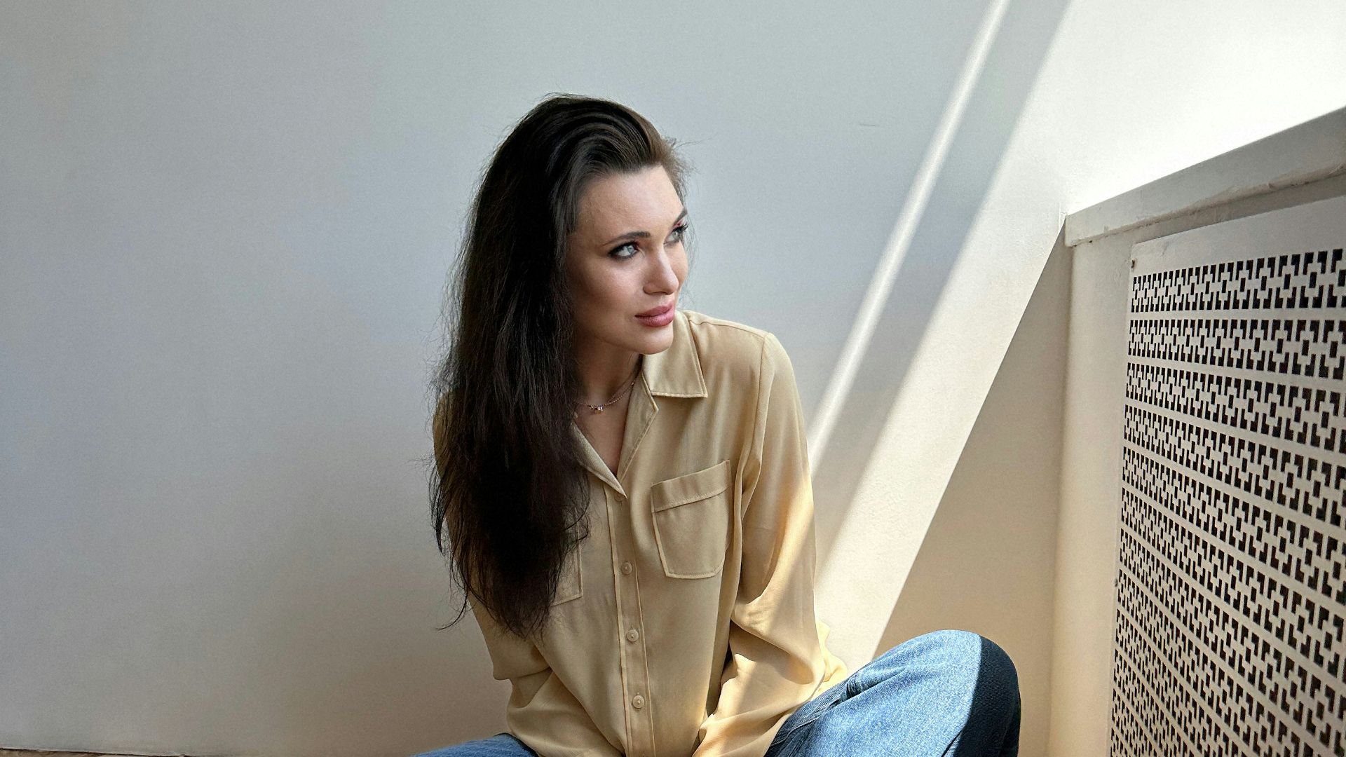a woman sitting on the floor with her legs crossed