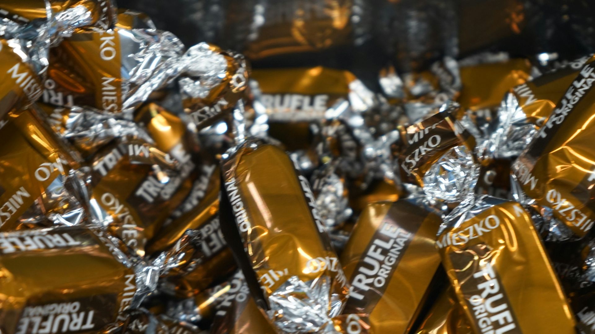 A pile of gold and silver foil wrapped candy bars