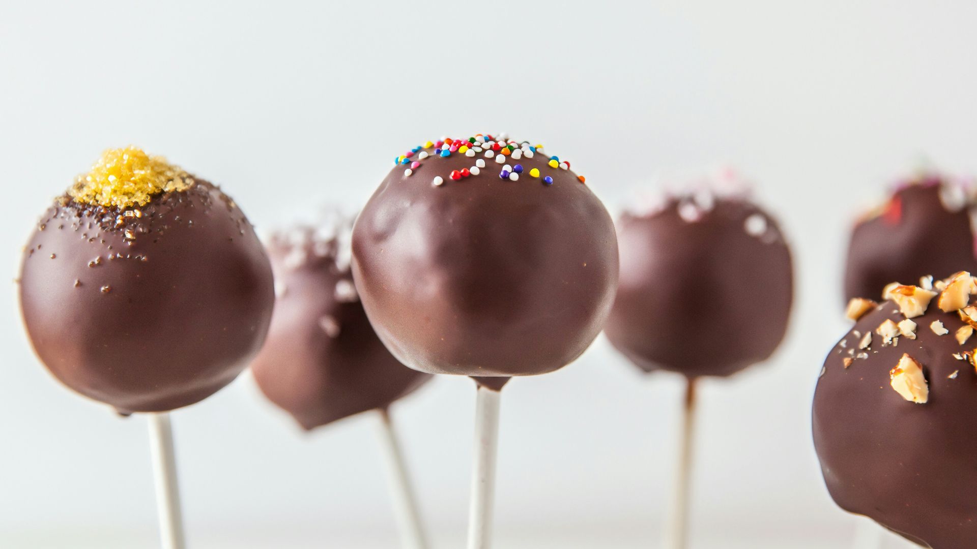 red and yellow lollipop on white surface