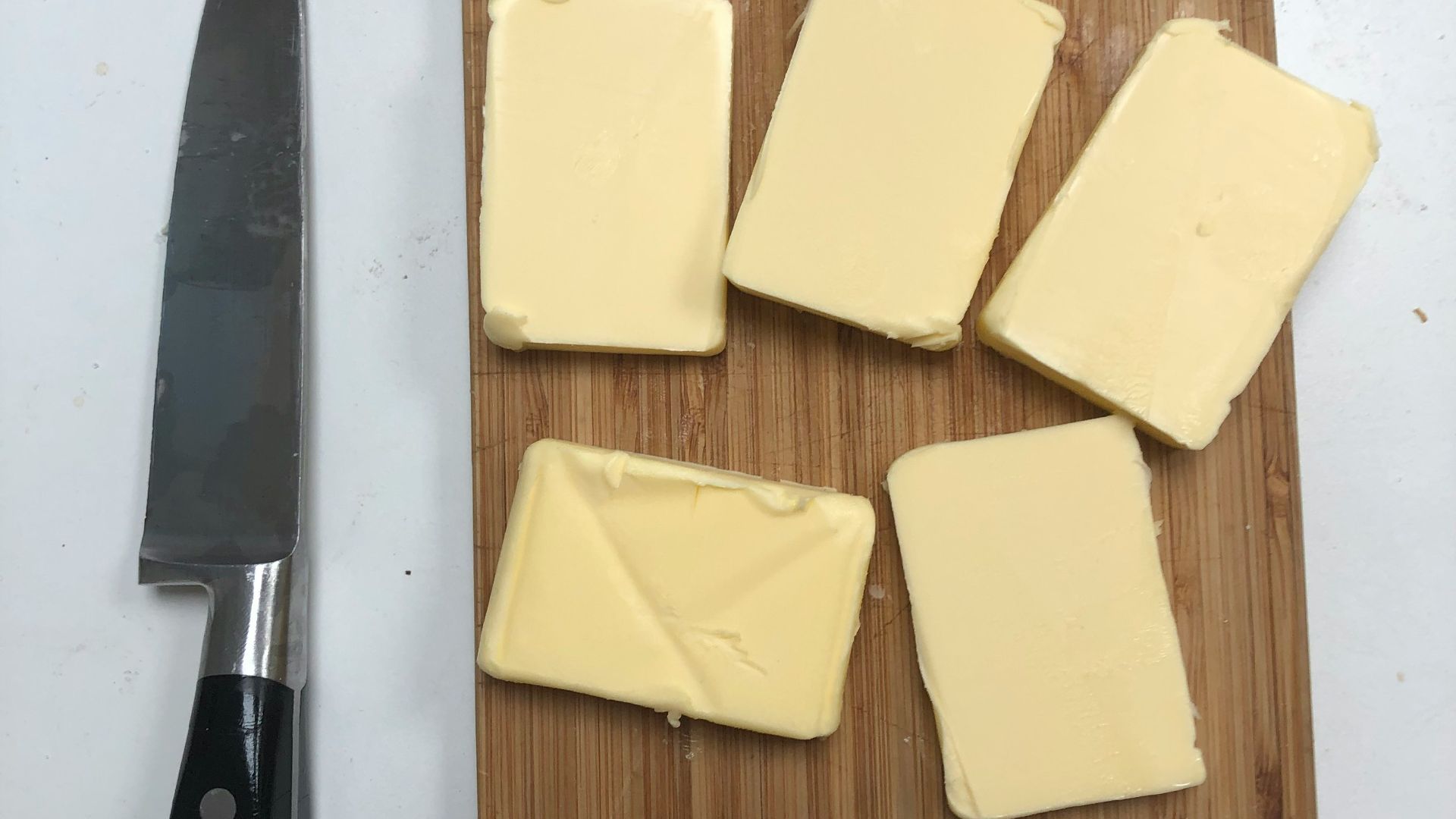 black handled knife beside cheese